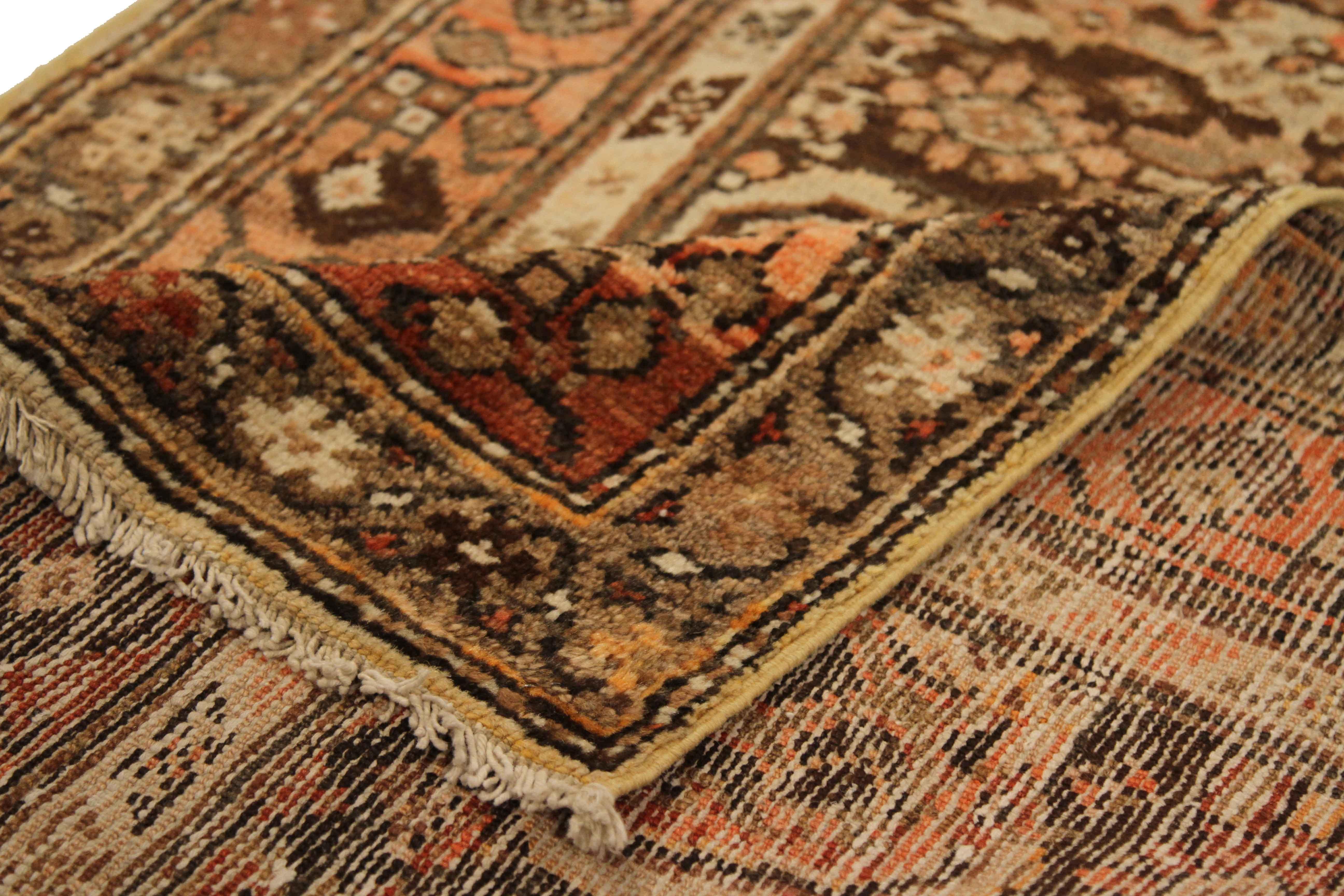 Made by handweaving high-grade wool, this antique Persian rug has its entire field covered with ornate design patterns featuring medallions and floral figures. It has a rich mix of brown, red, beige and ivory that will highlight wooden floors in