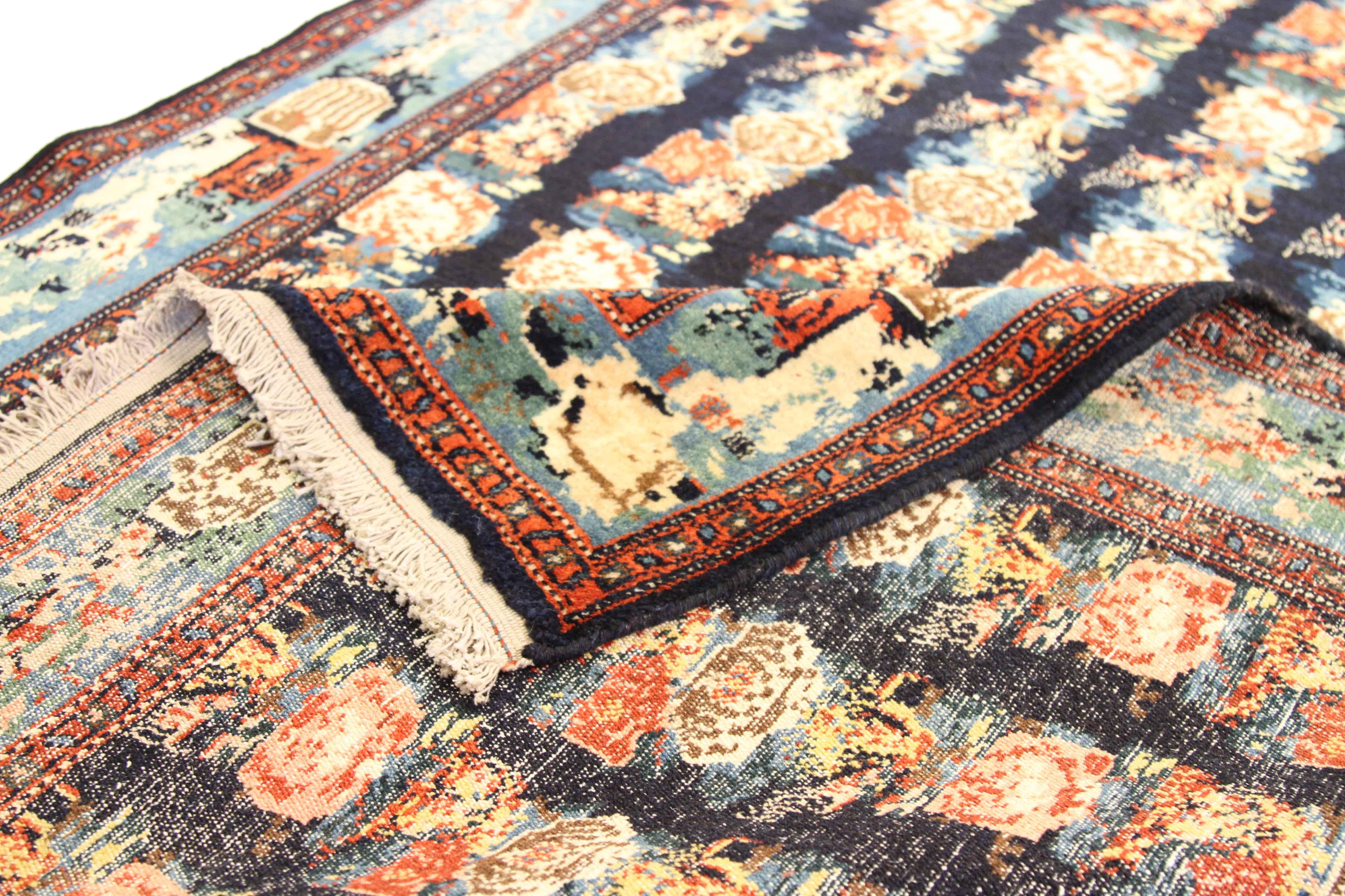 Antique Persian rug made by hand in the 1910s. It’s from the finest wool and vegetable dyes woven in the tradition of Seneh weavers. A captivating mix of black, blue, green and red make the repeating floral patterns easy on the eyes. It’s great for