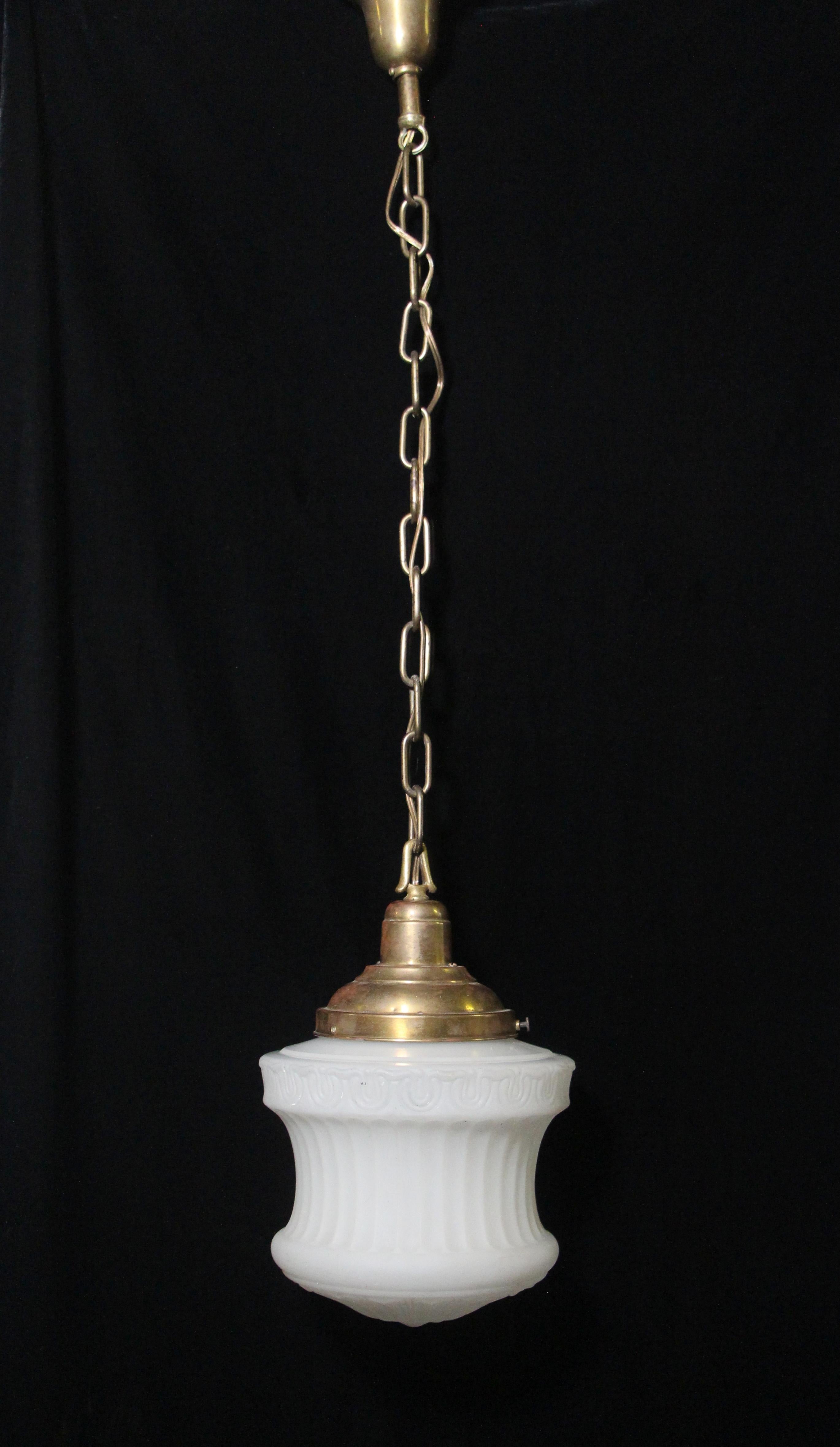 Antique 1910s cast glass pendant light with ornate Victorian detailing and fluting. Features new brass hardware and new wiring. The globe has some minor removable stains, which can be seen in the photos. Price includes cleaning and restoration. This