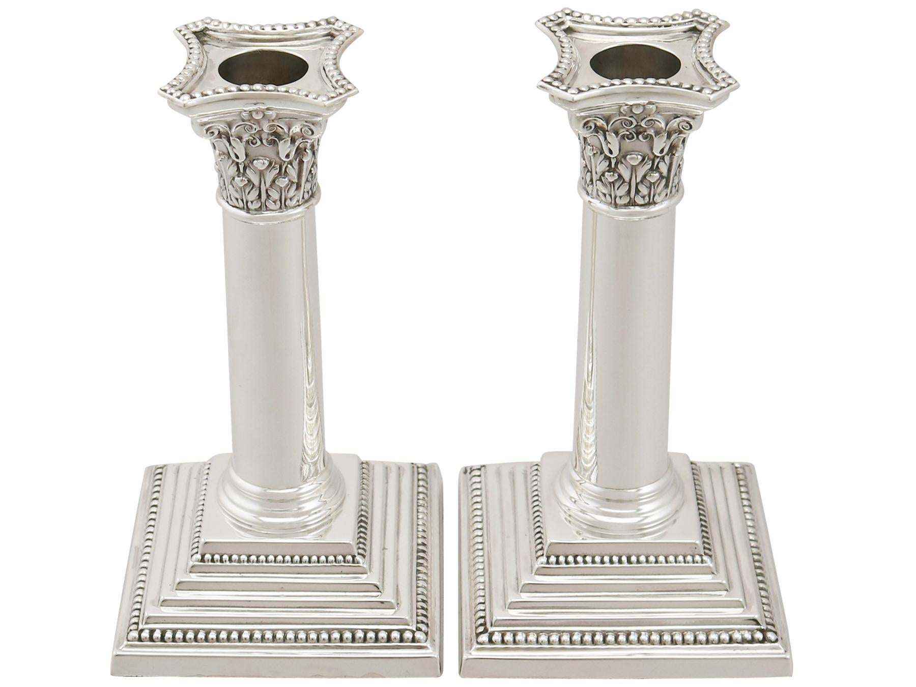 An exceptional, fine and impressive pair of antique George V English sterling silver candlesticks; part of our ornamental silverware collection.

These exceptional antique English sterling silver candlesticks have a plain cylindrical column to a