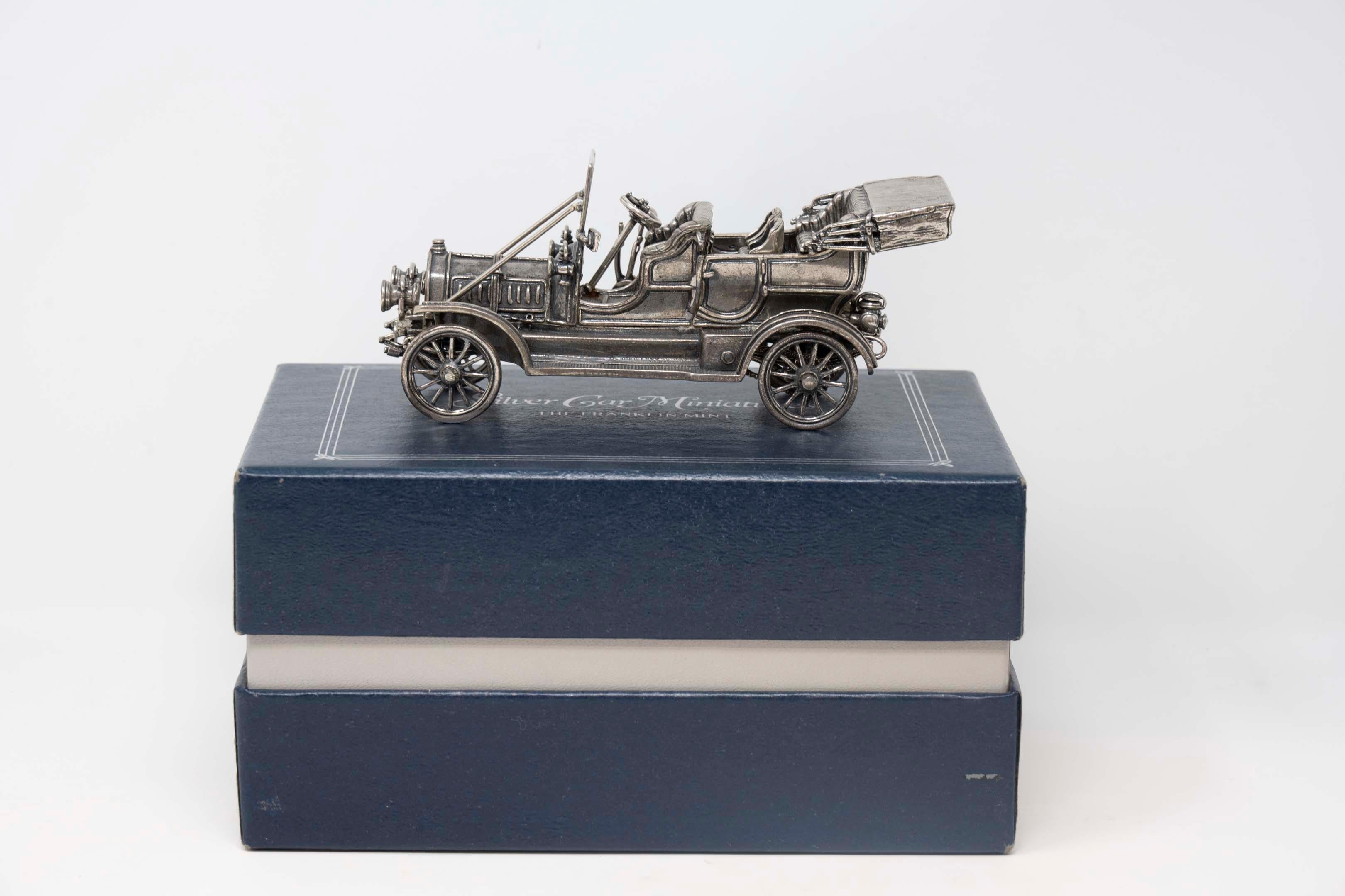Franklin Mint 1911 Delaunay-Belleville sterling silver miniature car with box. Measures 4 3/4 inches long x 2 1/4 inches tall 1 1/2 inches wide. Made in 1970-80, hallmarked. Weighs 229.3 grams, in good condition.
