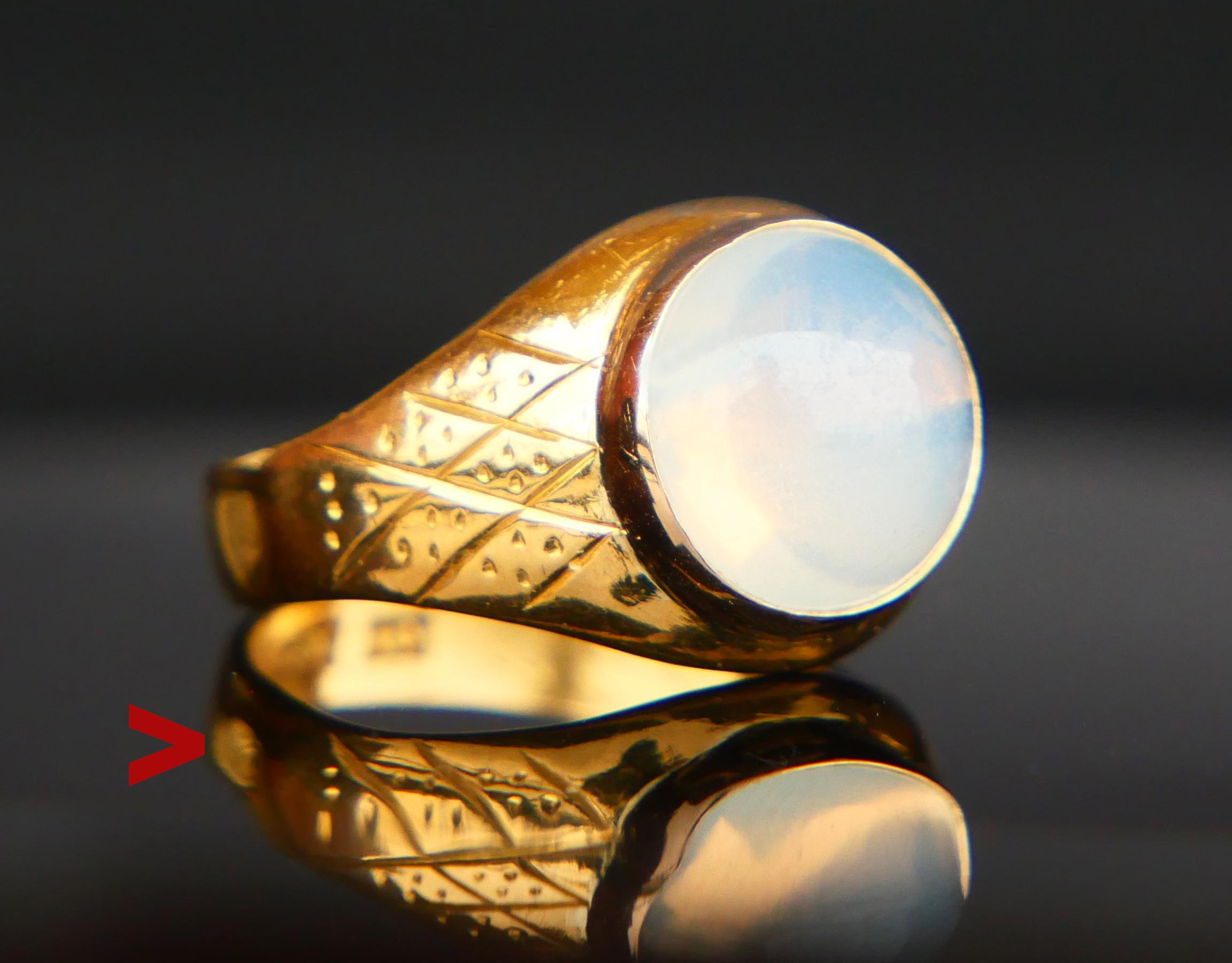 111 years old Swedish Moonstone Ring in solid 23K Gold. Wide shoulders have engraved ornaments, bezel set natural Moonstone measuring Ø 10 mm x 5.85 mm deep / ca. 5 ct. I suspect that the bezel is made in 18K Orange Gold, some color difference is