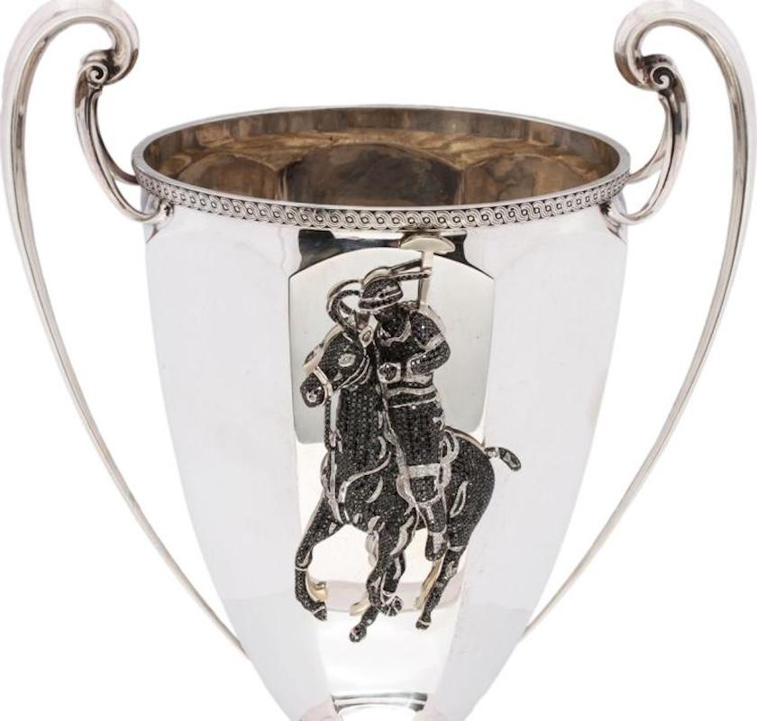 This magnificent sterling silver polo trophy was crafted by the estimable Tiffany & Co in 1911. The Adam's style urn body and top is brilliantly crafted in the classical vein, with simple braided trim, two elegant long handles, and a neoclassical