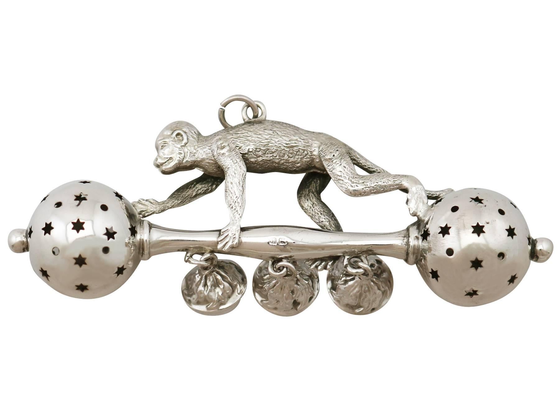 An exceptional, fine and impressive, unusual antique George V sterling silver baby rattle; part of our diverse silverware collection.

This exceptional antique sterling silver baby rattle has a barbell shaped form.

This unusual silver baby rattle