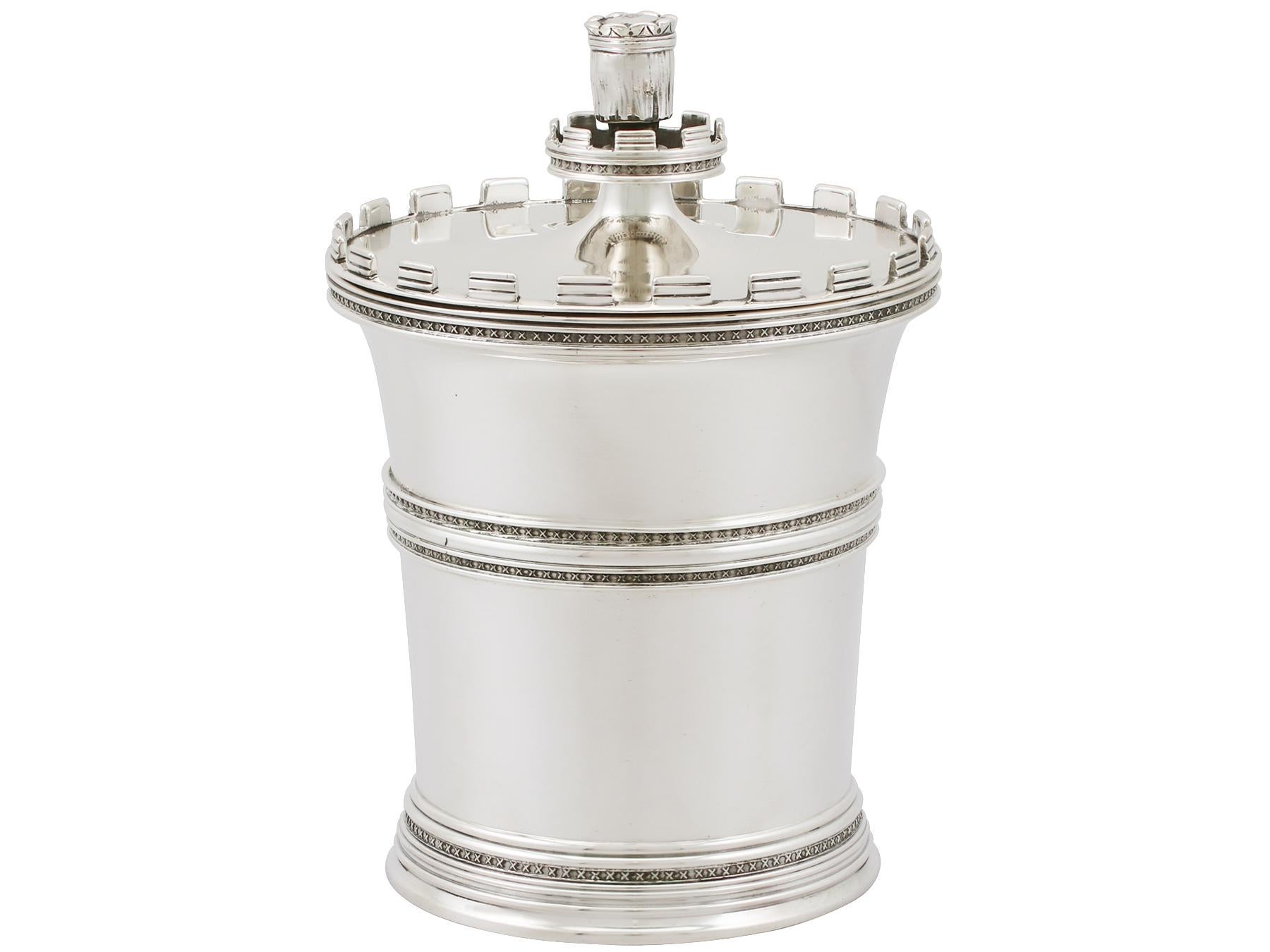 An exceptional, fine and impressive antique George V English sterling silver tea caddy; an addition to our 20th century silverware collection.

This exceptional antique George V sterling silver tea caddy has a tapering cylindrical form.

The surface