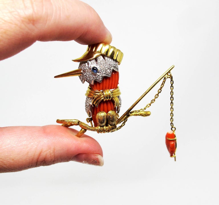 This playful, 3-dimensional coral and diamond fishing bird brooch is sure to spark up a great conversation!  Bursting with color and texture, this delightful piece tells a story with only a glance at its incredible fine details. We especially love