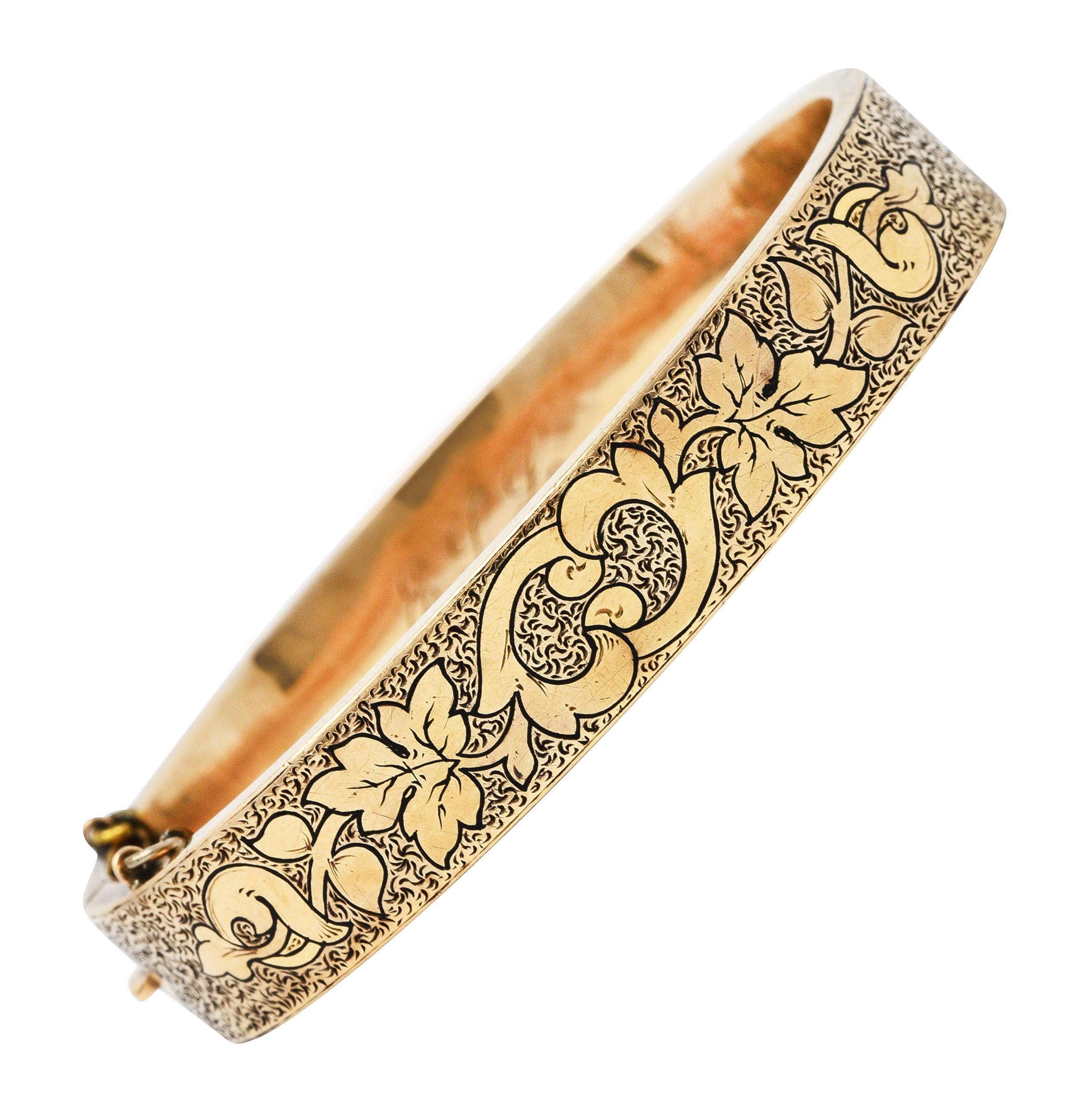 Pair of bangle style bracelets designed with stylized engraving

Featuring scrolling grapevine and foliate motif

Symbolizing a fruitful and prosperous marriage

With organic texture throughout

Bracelets open on a hinge

Completed by press release