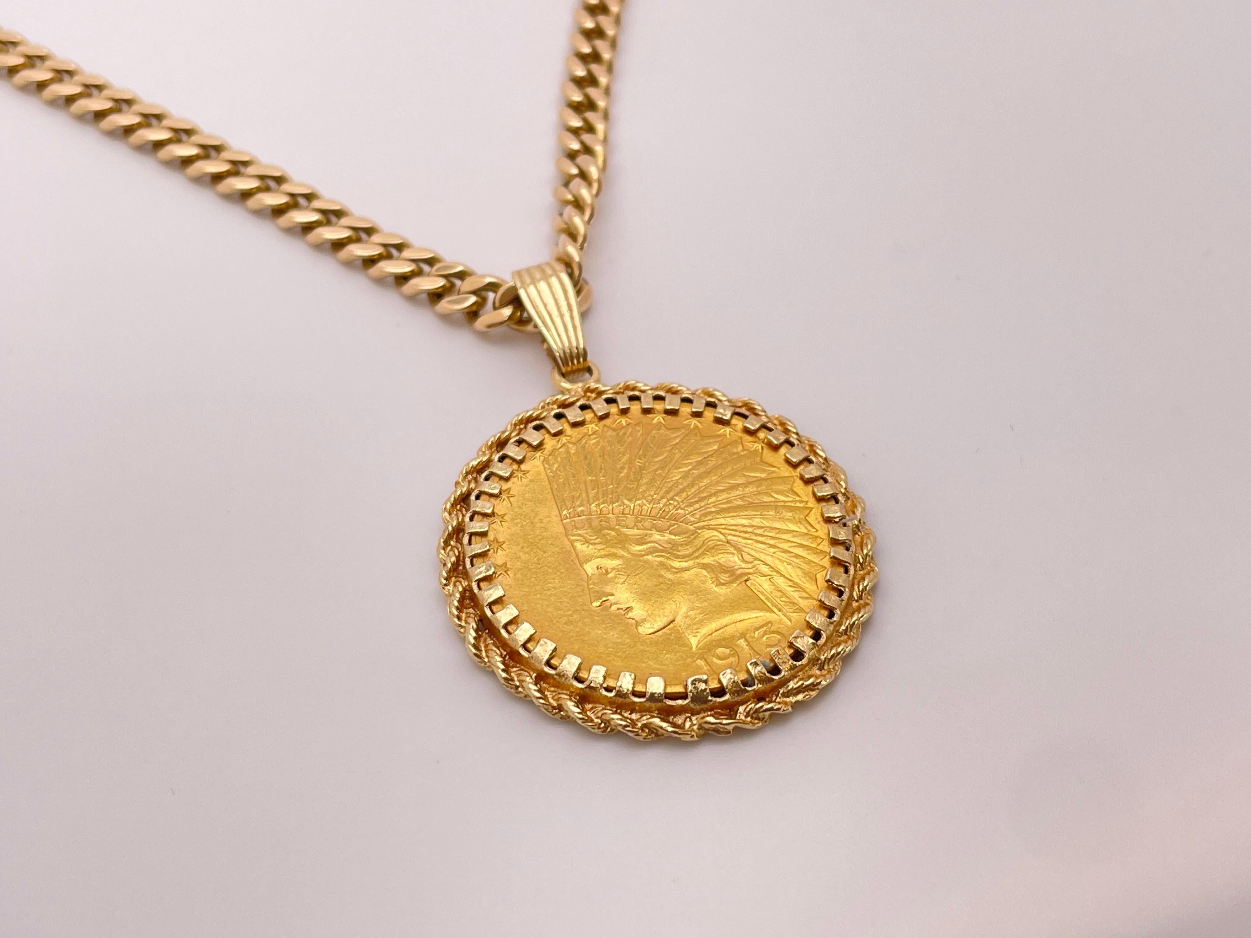 A 1913 $10 Indian head eagle gold coin pendant, mounted in a 14K yellow gold twisted vine frame, accompanied by a 14K yellow gold 16-inch chain.

