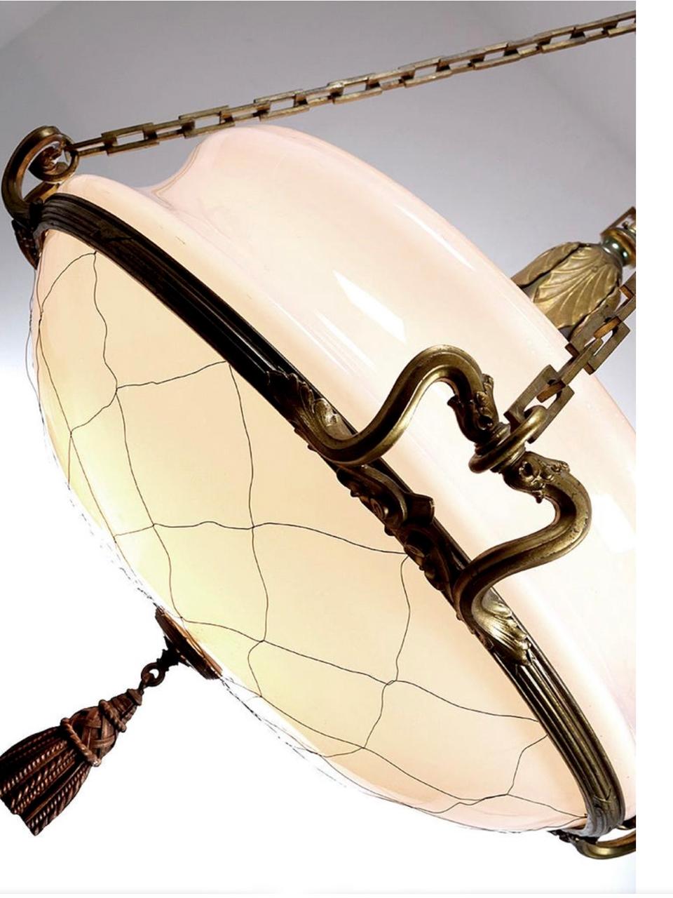 These lamps were once gas and later electrified. We were lucky to acquire a nice collection of these impressive fixtures. It’s something that will not happen again. Each lamp is bronze with a heavy 26 inch milk glass shade and weigh about 50 pounds.