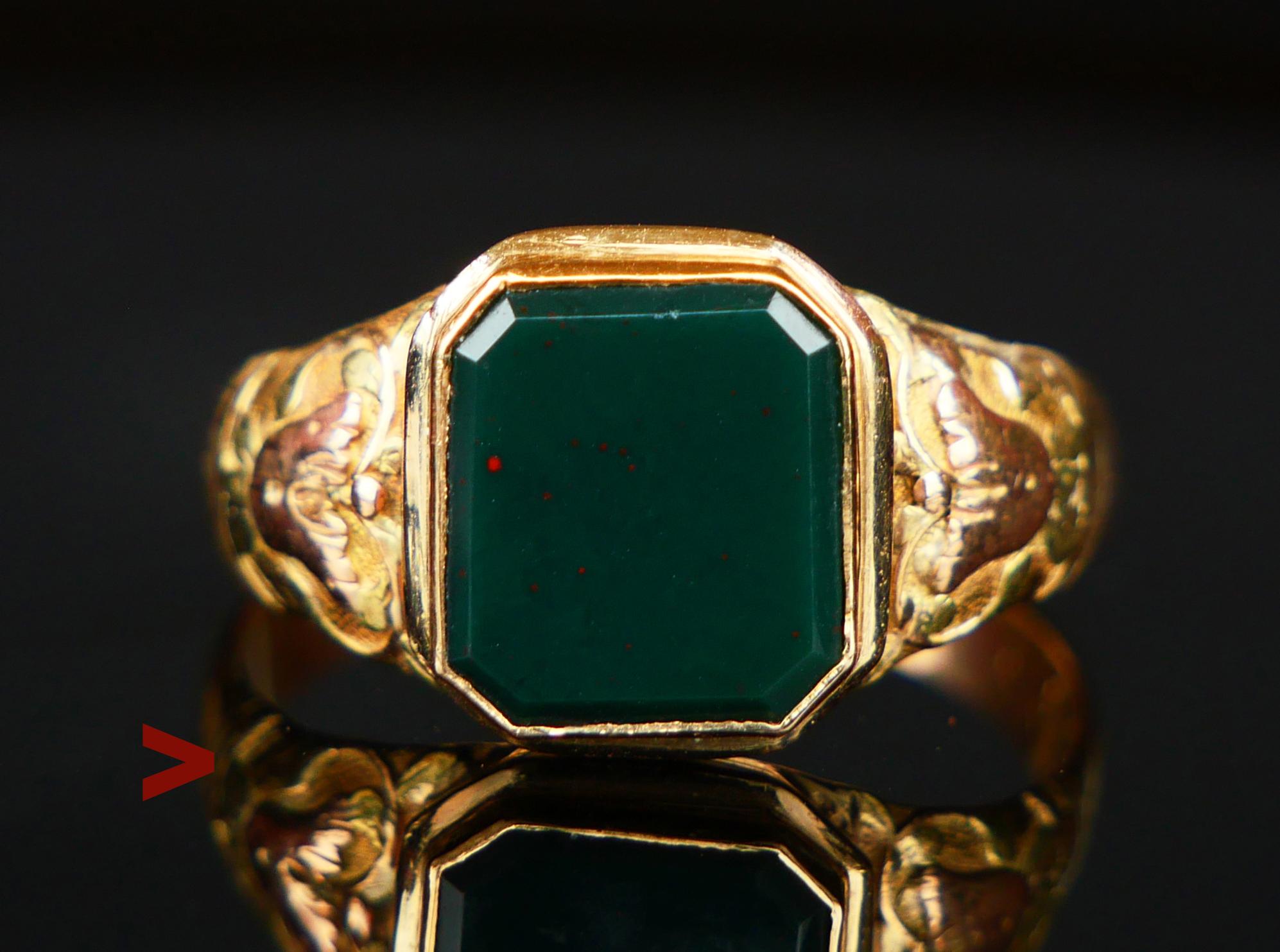 Unisex type German ca 1920s -1930s Signet Ring in solid 14K Yellow Gold with carved shoulders and bezel set emerald cut  natural Blood - stone, color is dark Green color with red dots, measures ca. 9.5 mm x 8.5 mm  / ca. 4.5 ct. 

Band hallmarked