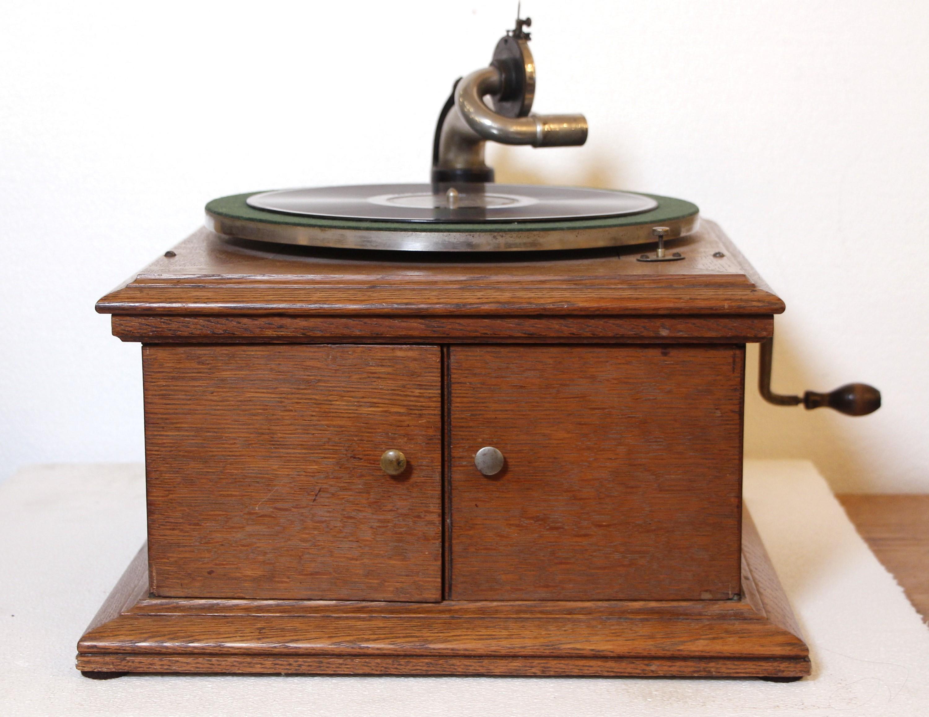 Original 1914 Model VV-VI Victor Talking Machine 78 speed record player housed in the original oak case with two doors that open to control the volume. Includes five 78 speed records. Restored to working condition. Uses a hand crank, no electricity
