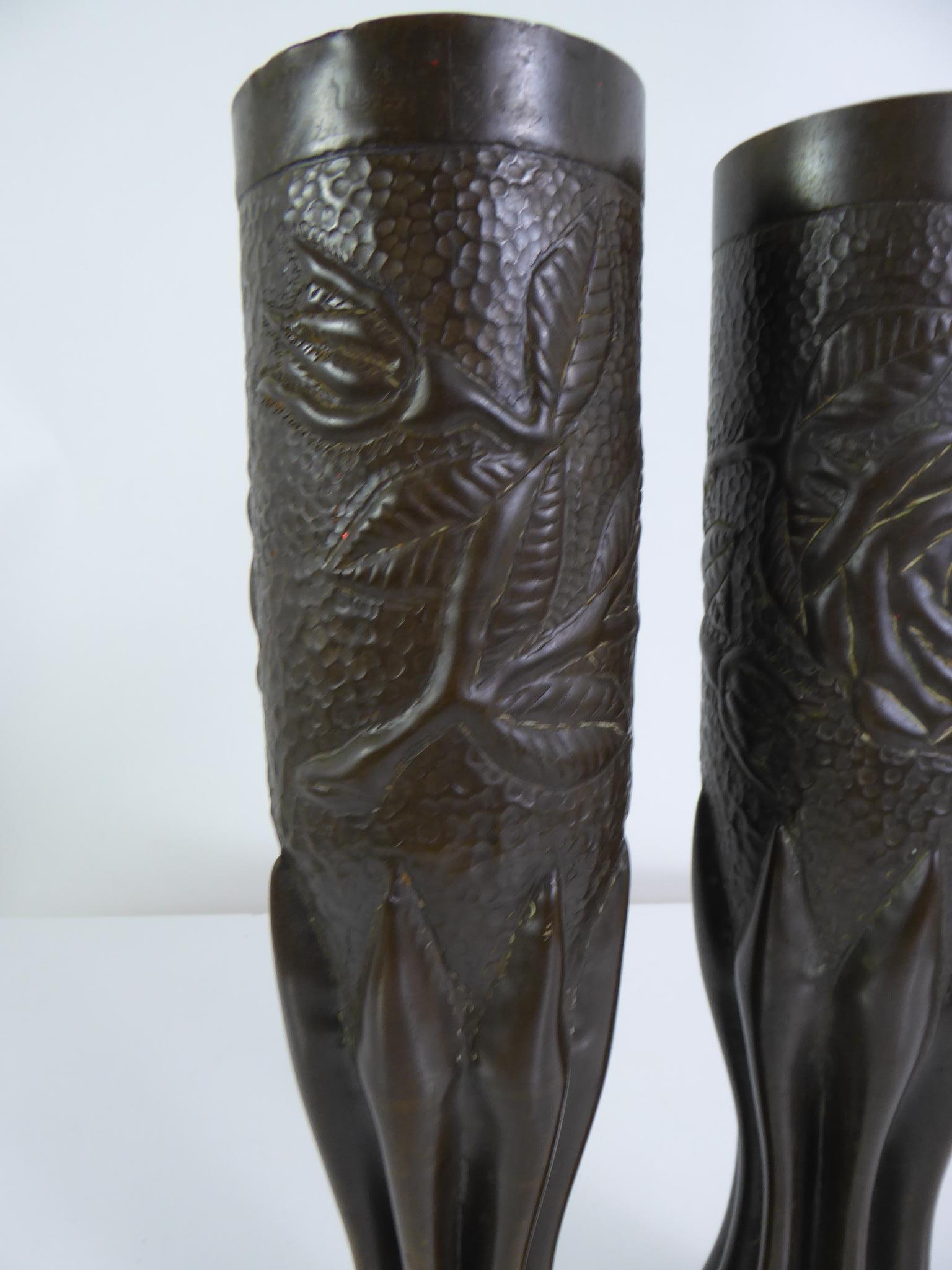 World War I Trench Art Pair of gorgeous decorated Vases made from bronze Artillery Shell casings. These vases are beatifully decorated with embossed images of flowers thus giving them a Romantic theme to a traumatic situation.

Trench Art is given