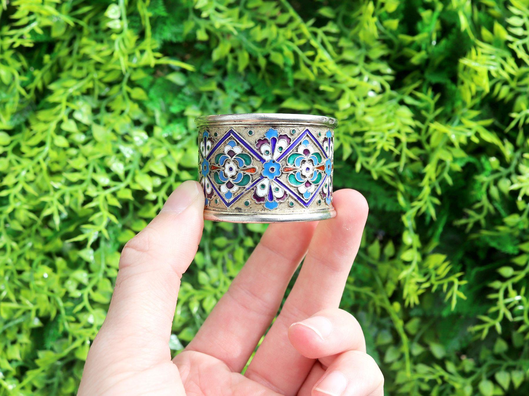 An exceptional, fine and impressive antique Russian silver gilt and polychrome cloisonné enamel napkin ring; an addition to our Russian silverware collection.

This exceptional antique Russian silver gilt napkin ring has a cylindrical form.

The