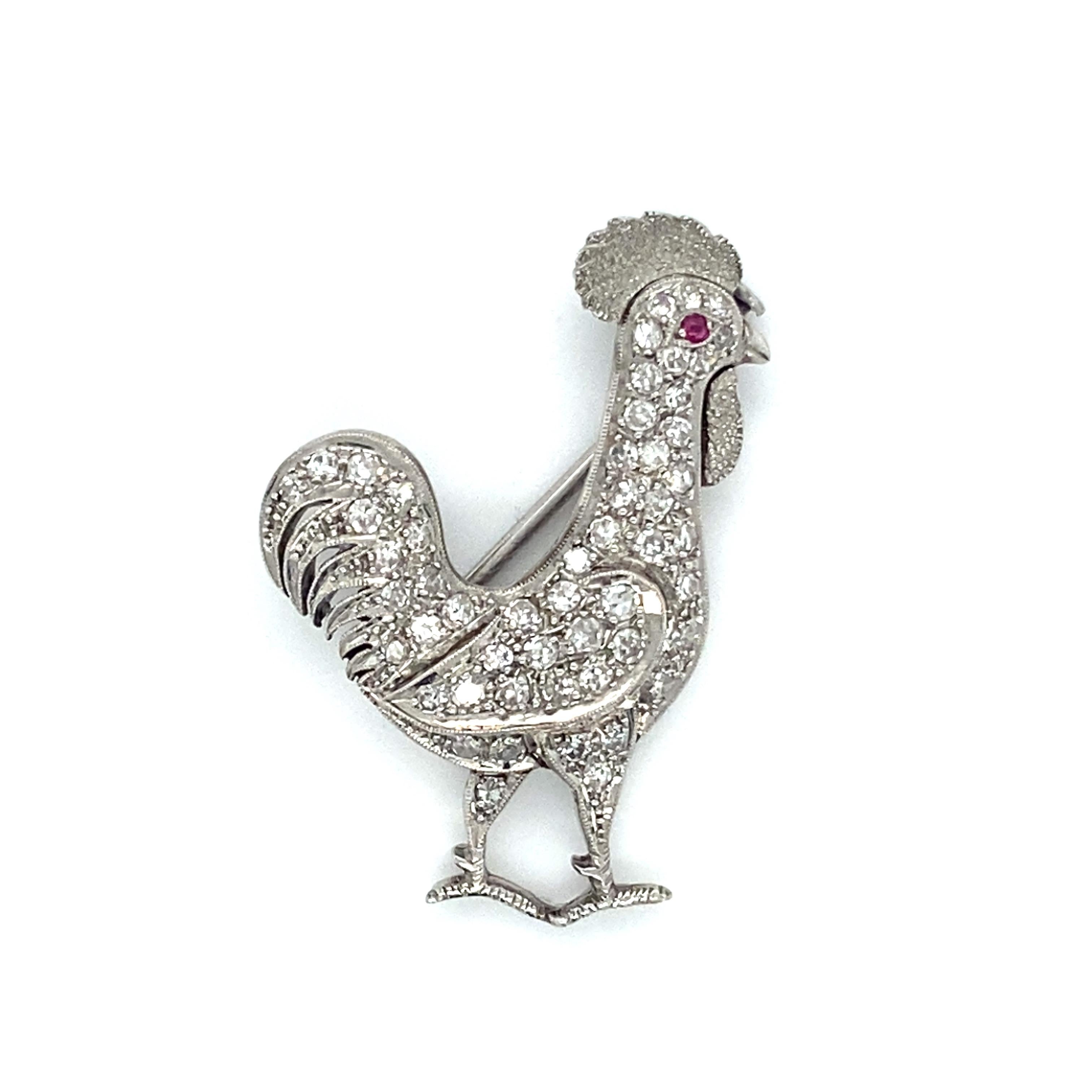 Item Details: 
Metal Type: Platinum
Weight: 6.3 Grams
Measurements: 1.4 inch length x 1 inch width 

Diamond Details:
Carat: 1 Carat Total Weight
Cut: Single Cut Diamonds
Color: G
Clarity: VS

Features: 
Accent Ruby gemstone (eye of rooster)
Made in