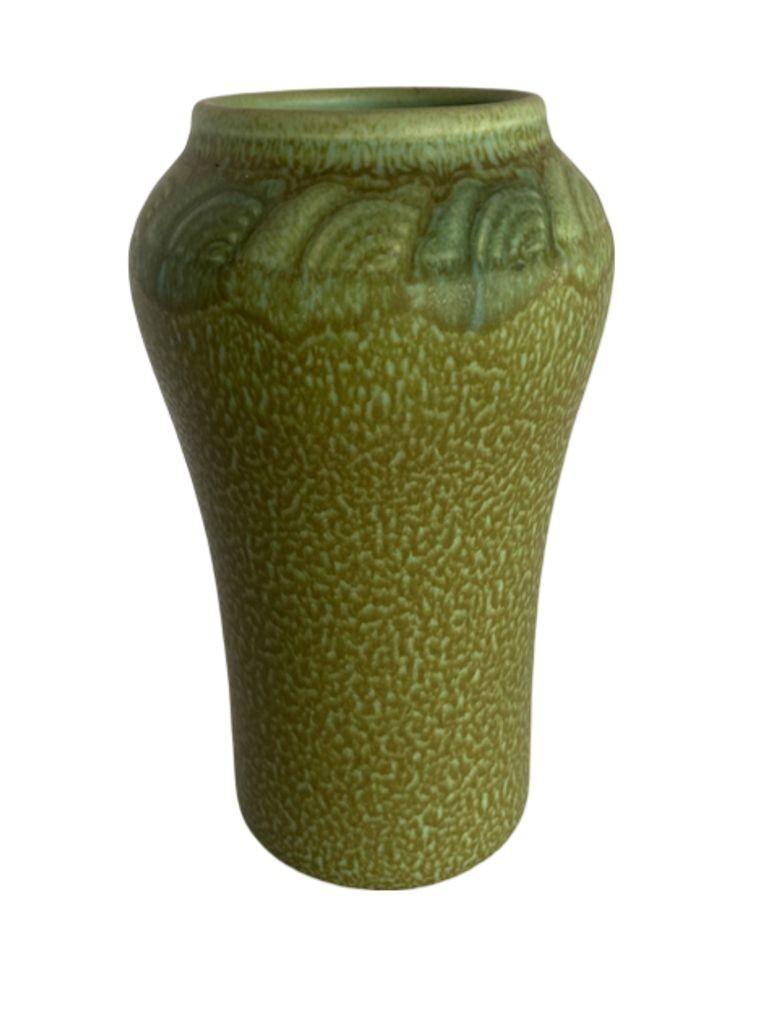 This stunning vase from, Ohio, around 1901, a Rookwood Pottery Arts and Crafts vase in matte very moss blue-green hue.
Matte glazed and incised, designated as form number 935E, was crafted. Its surface showcases a mottled and textured finish, adding
