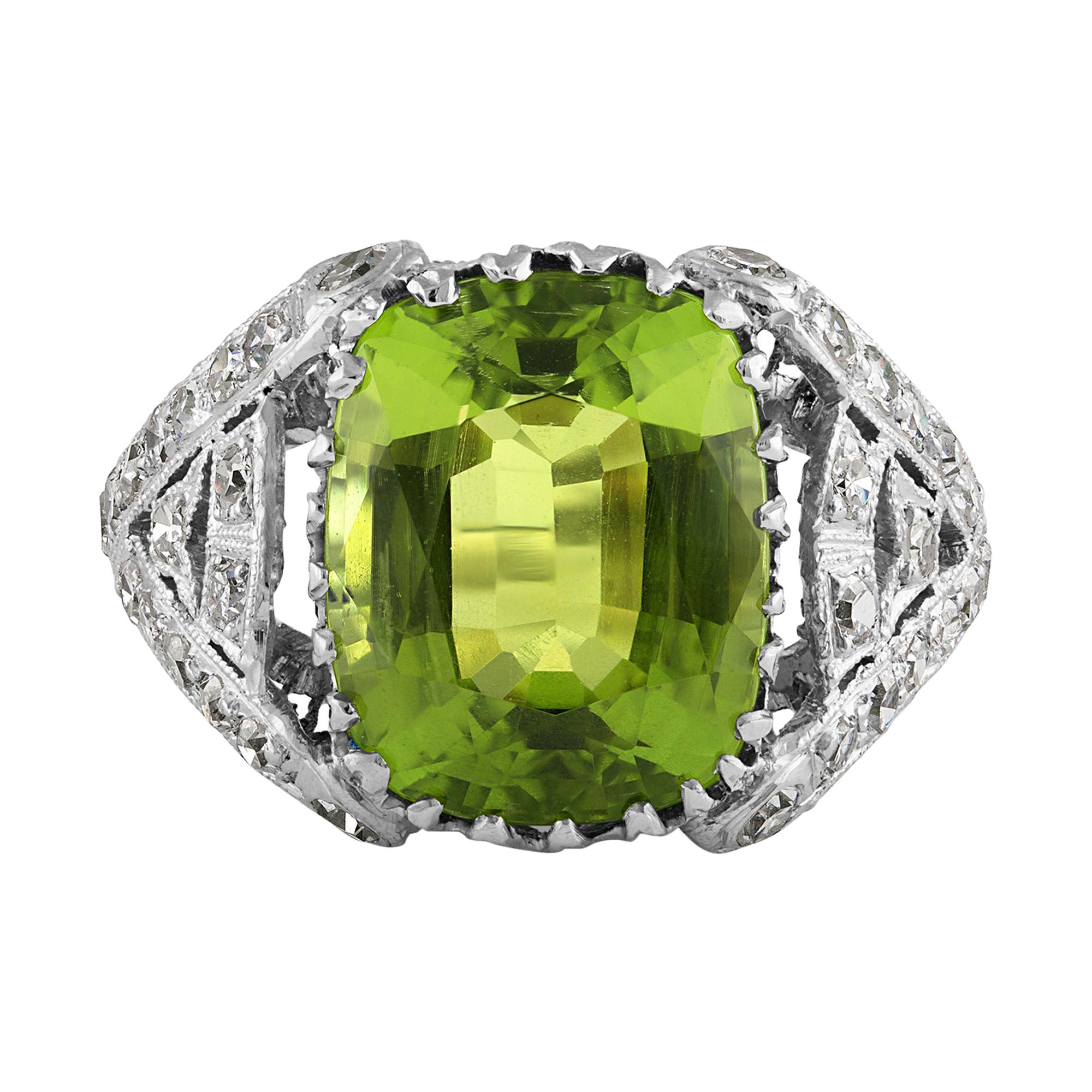Antique GIA 6.73ct Old Cushion Peridot and Diamond Edwardian Platinum Ring.
From the mid-1800s, Peridot was a favored stone in jewelry, reaching the height of its popularity during the aesthetic period of the Victorian era and the reign of Edward