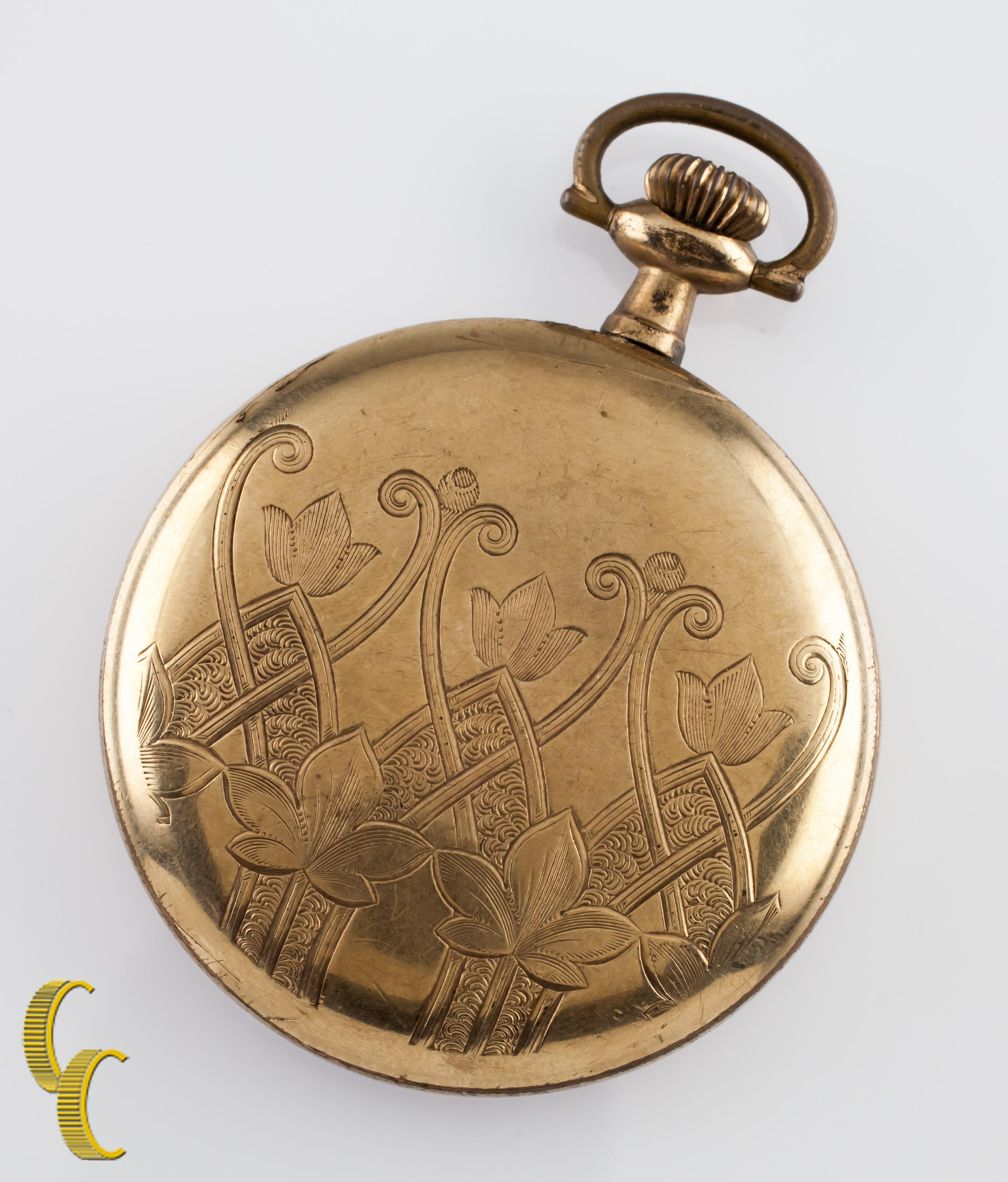 Beautiful antique Elgin pocket watch with white dial including cobalt blue hands.
Yellow gold-filled case with intricate hand-etched design on reverse of case.
Black numbers.
Case serial #5053879.
7-jewel Elgin movement serial #18682455.
Year of