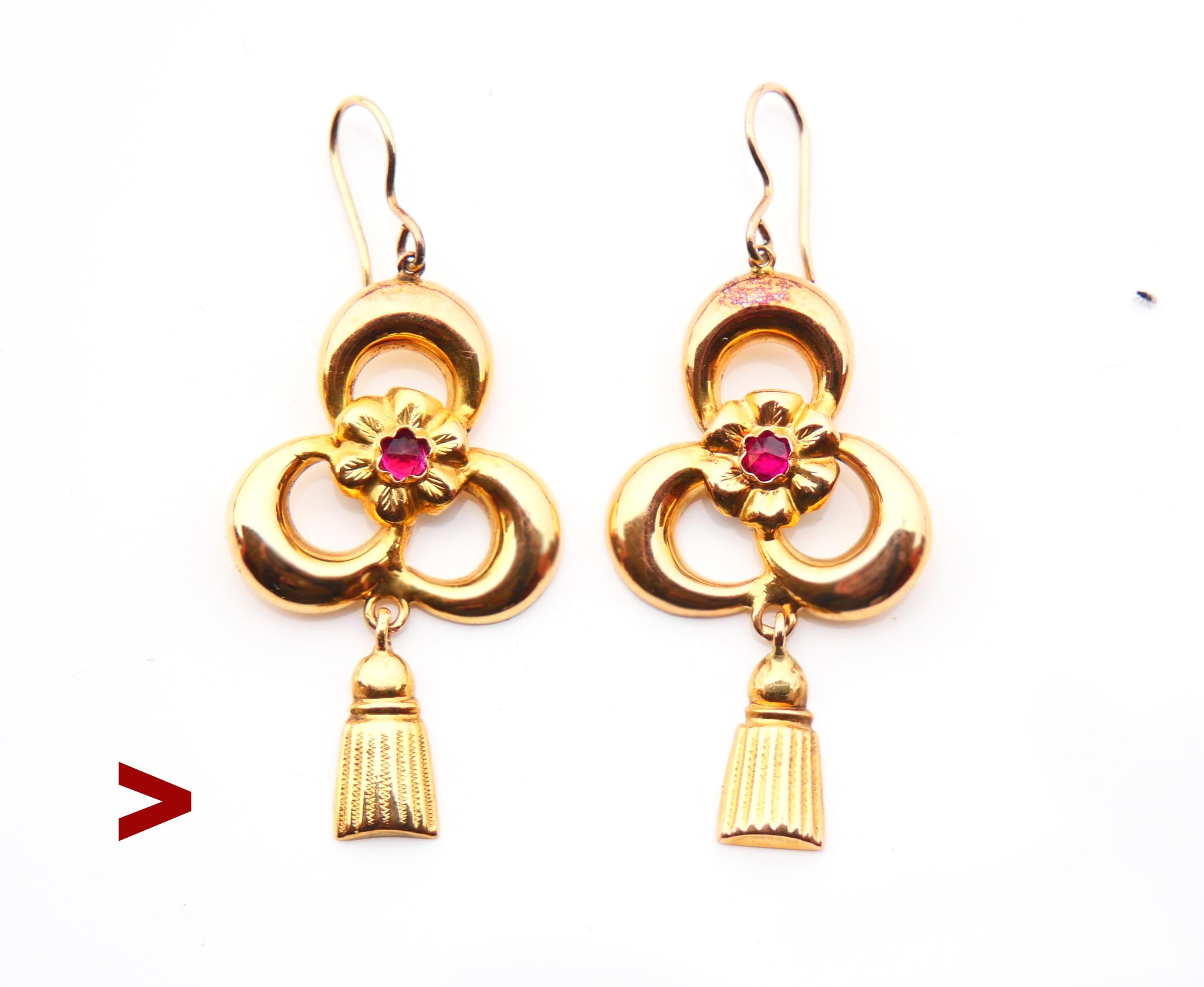 A pair of Art Nouveau period 108 years old Gold earrings decorated with flowers ans rose cut Rubies. Freely suspended main pendants and tassel shaped dangles.

Each earring is 57 mm long suspended including the hook x 24 mm wide x 4 mm deep. Weight: