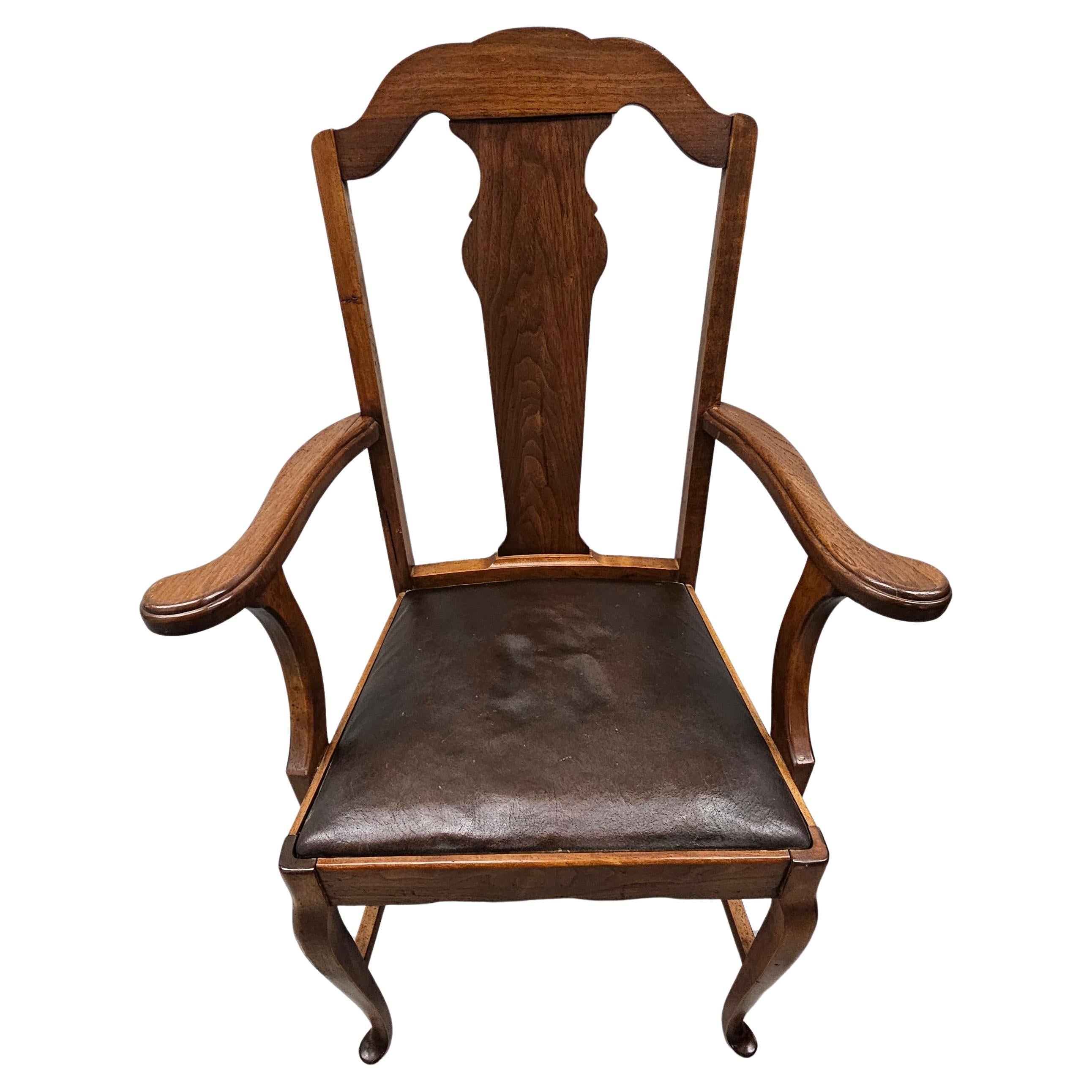 A 1916 Sikes Furniture Company Walnut and Leather Upholstered Seat Armchair. Measures 26
