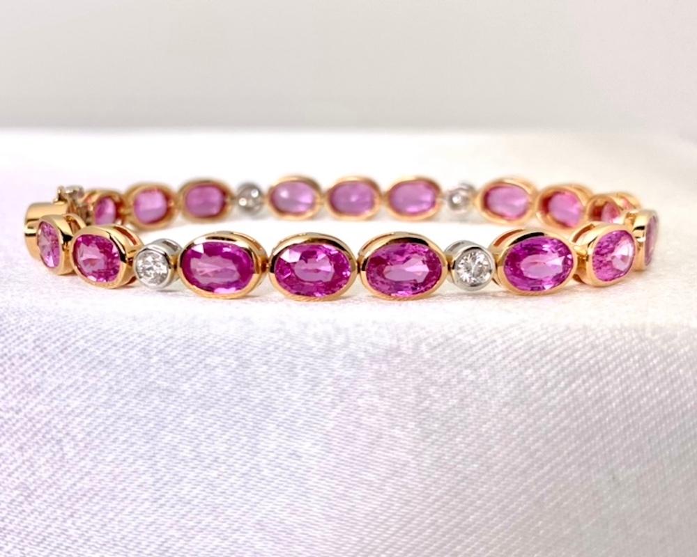 This stunning 18k white and rose gold tennis bracelet features over 19 carats of bright, lively pink sapphires and scintillating white diamonds in a sophisticated and modern design. The gorgeous pink gems are set in rose gold bezels to highlight