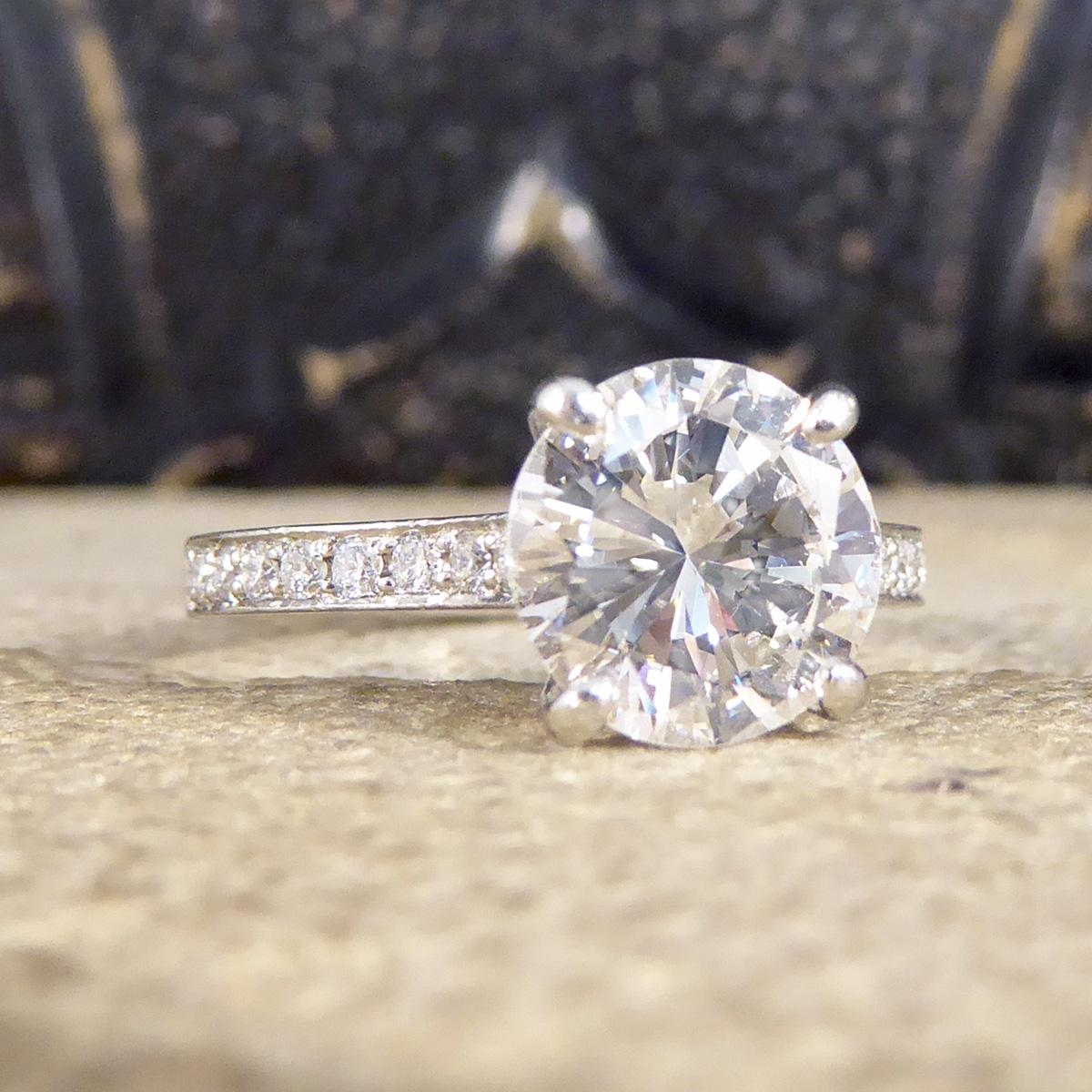 This beautifully sparkly engagement ring holds clear and bright Round Brilliant Cut Diamond weighing 1.91ct in a four claw setting. The centre Diamond itself has a high clarity grading of VVS2 showing the quality of the stone. A classic solitaire