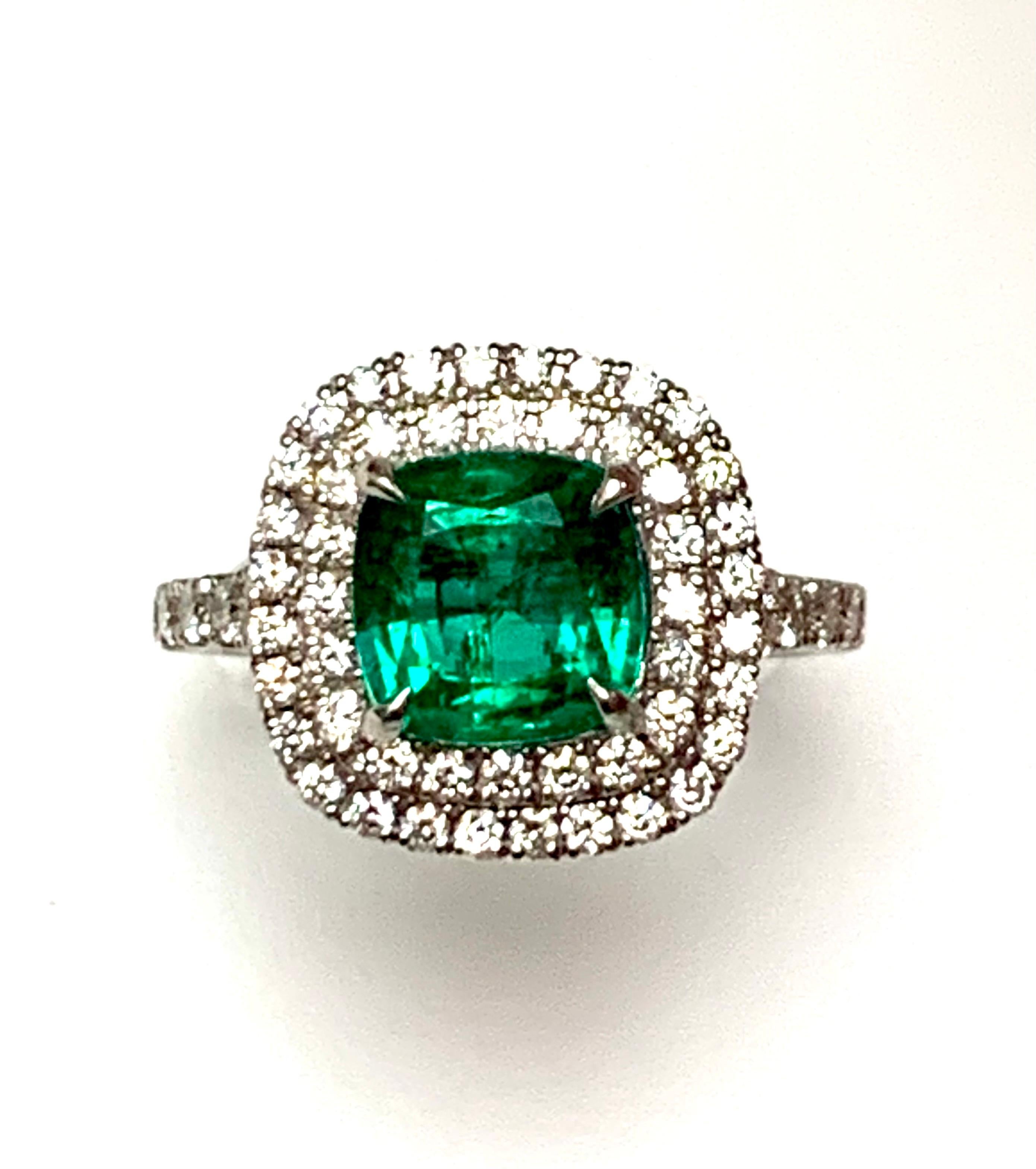 1.92 Carat cushion cut Zambian emerald set in 18kw ring , pave set diamonds double halo , diamonds half eay on the shank.