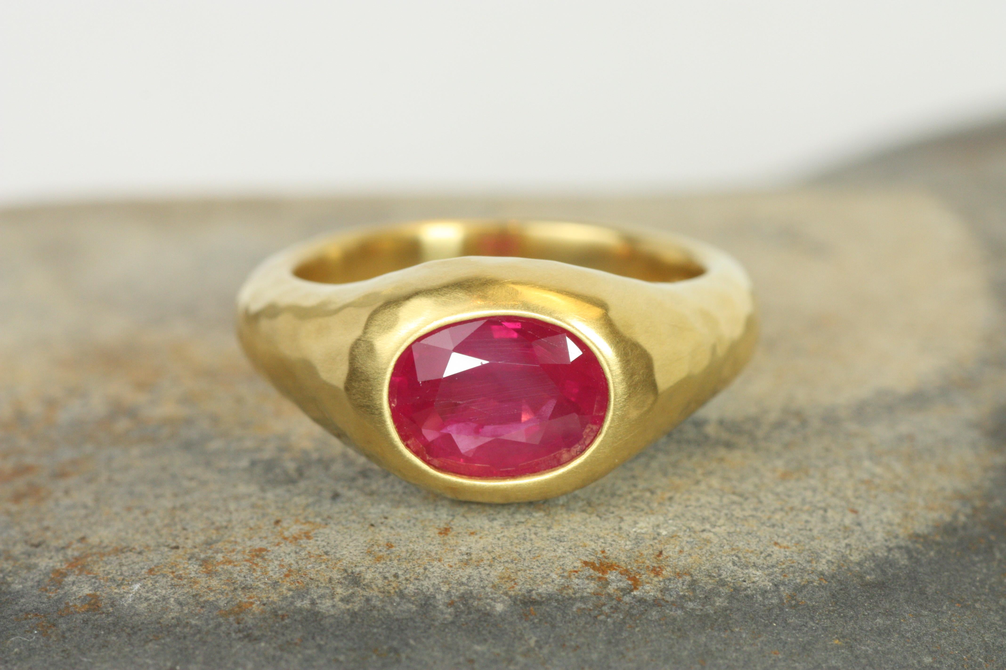The deep red hue of the 1.92ct ruby is enhanced by its unique setting in soft-hammered 22K yellow gold. The faceted cut of the ruby allows light to dance through the stone, adding brilliance to its rich color. This gypsy ring is handcrafted and