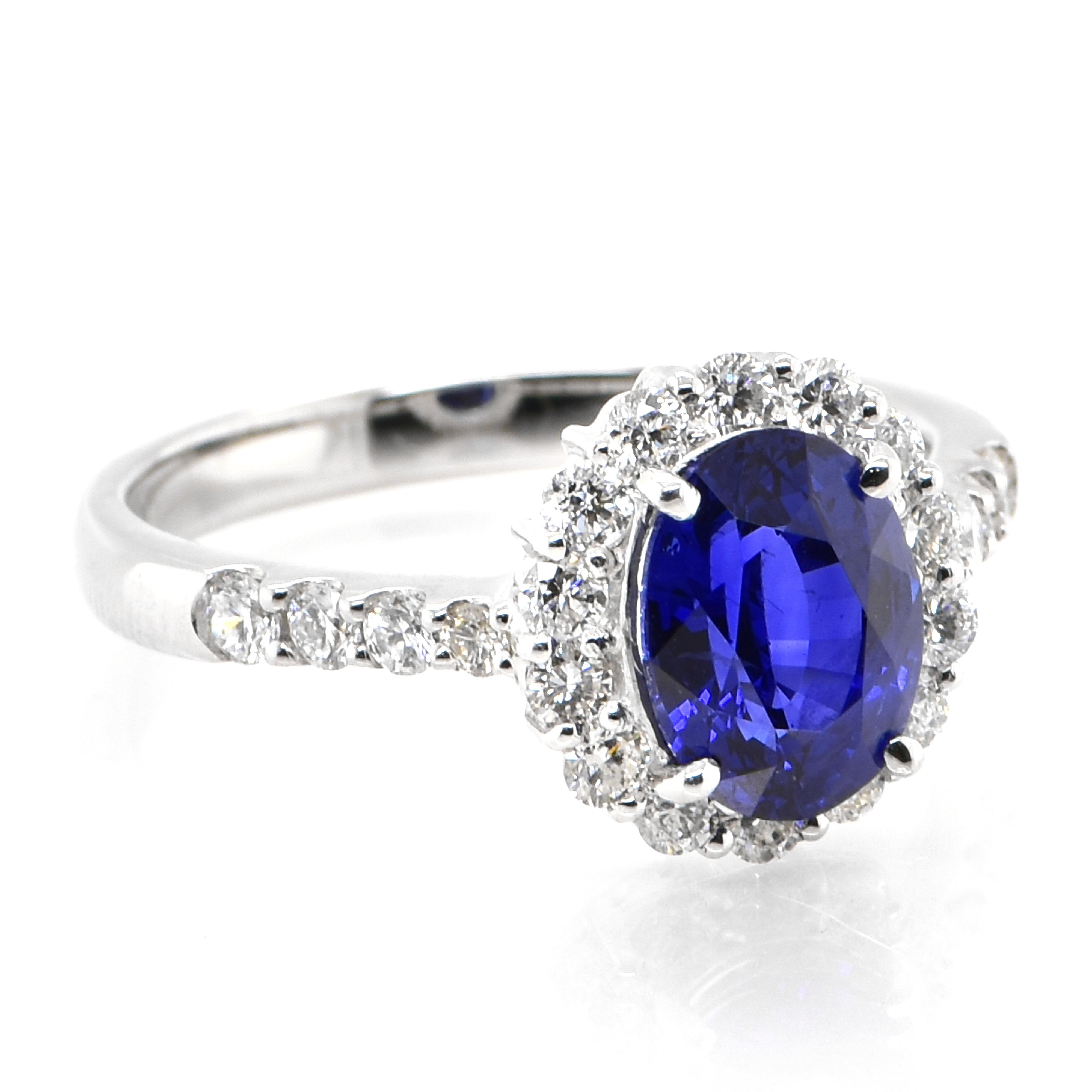 Modern 1.92 Carat Natural Royal Blue Sapphire and Diamond Halo Ring Made in Platinum For Sale