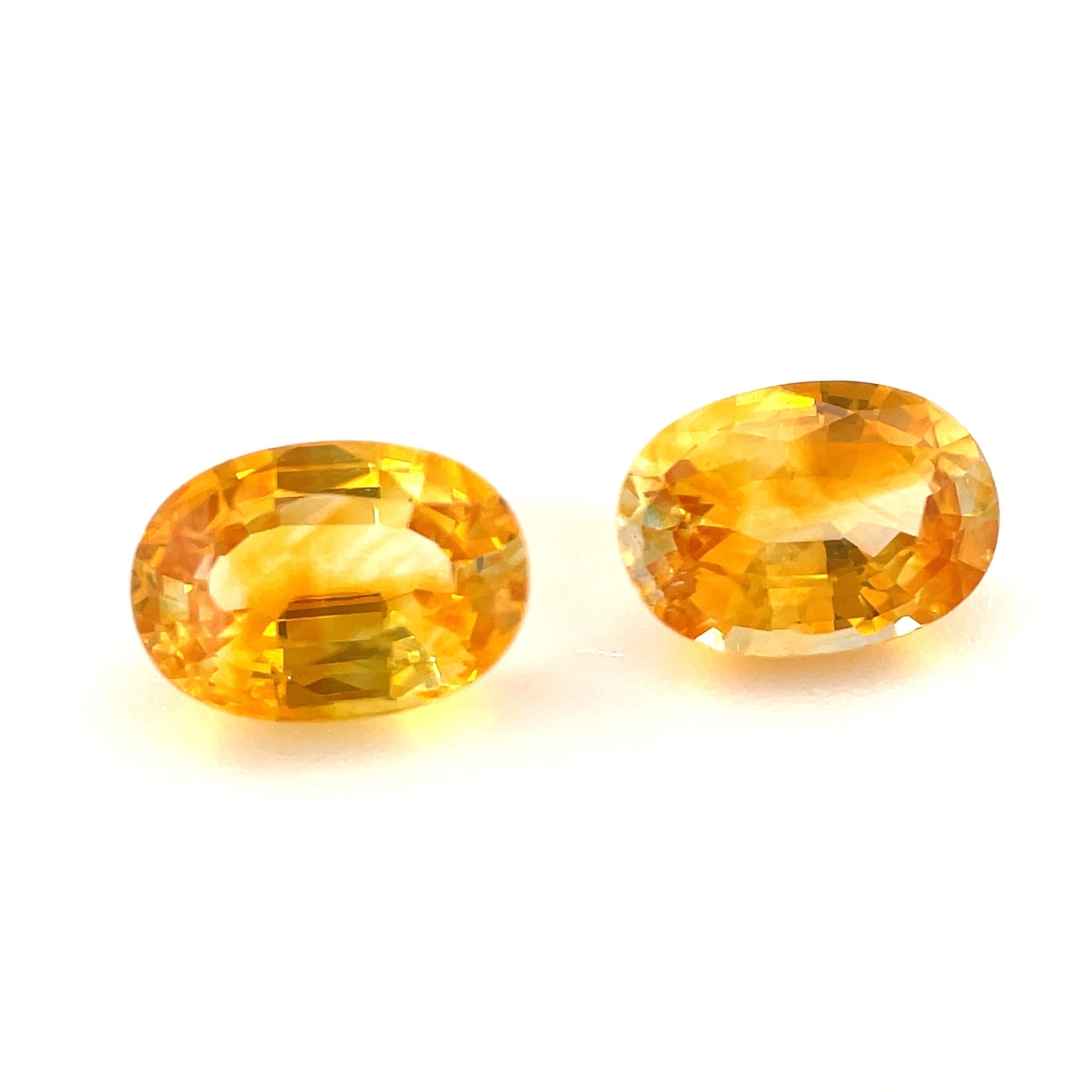 This sparkling pair of warm, golden yellow sapphires are like crystallized sunshine! Weighing 1.92 carats total, these gems have beautiful, rich color and they are eye-clean. They are extremely well-proportioned ovals that will lend themselves to
