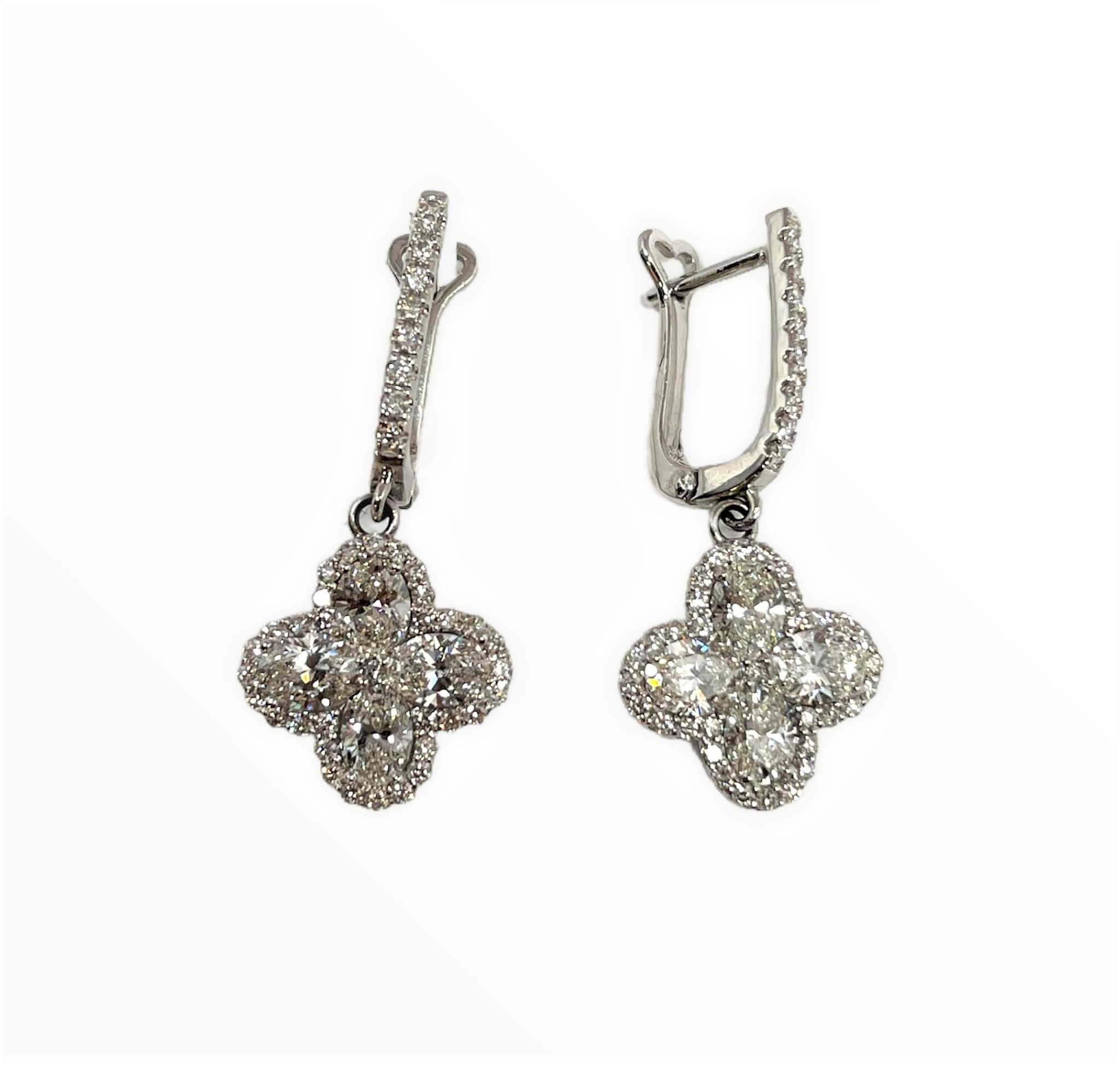 These gorgeous diamond earrings feature 8 oval shape diamonds weighing 1.92 ct graded E-F, VS1-VS2 surrounded by 80 diamonds weighing .68 ct set in 18k white gold