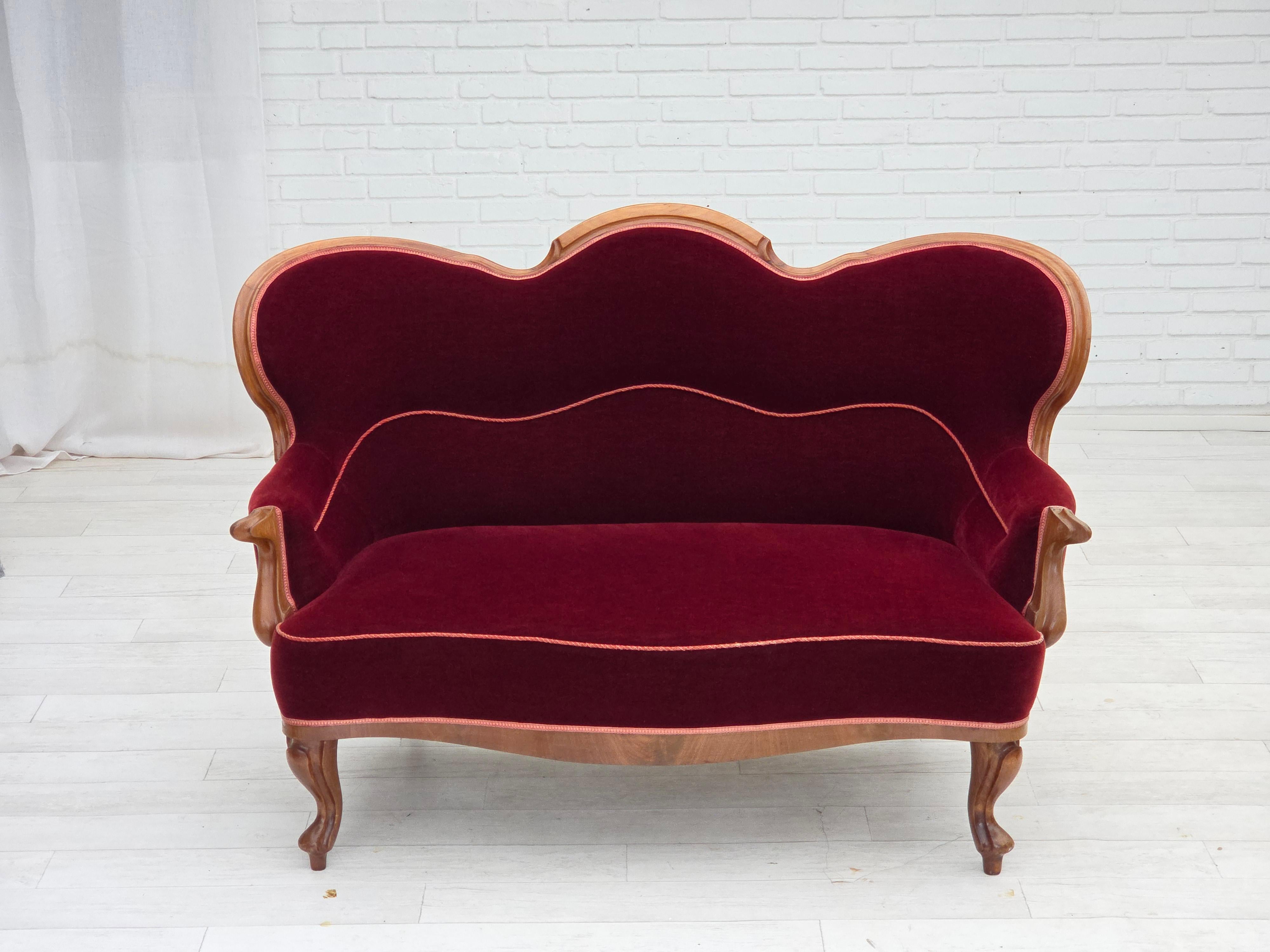 1920s, Danish 2-seater sofa. Cherry-red furniture velour, ash wood, brass springs in the seat. Sofa was reupholstered about 20 years ago by craftsman. Very good condition: no smells, no stains and stable construction. Manufactured by Danish