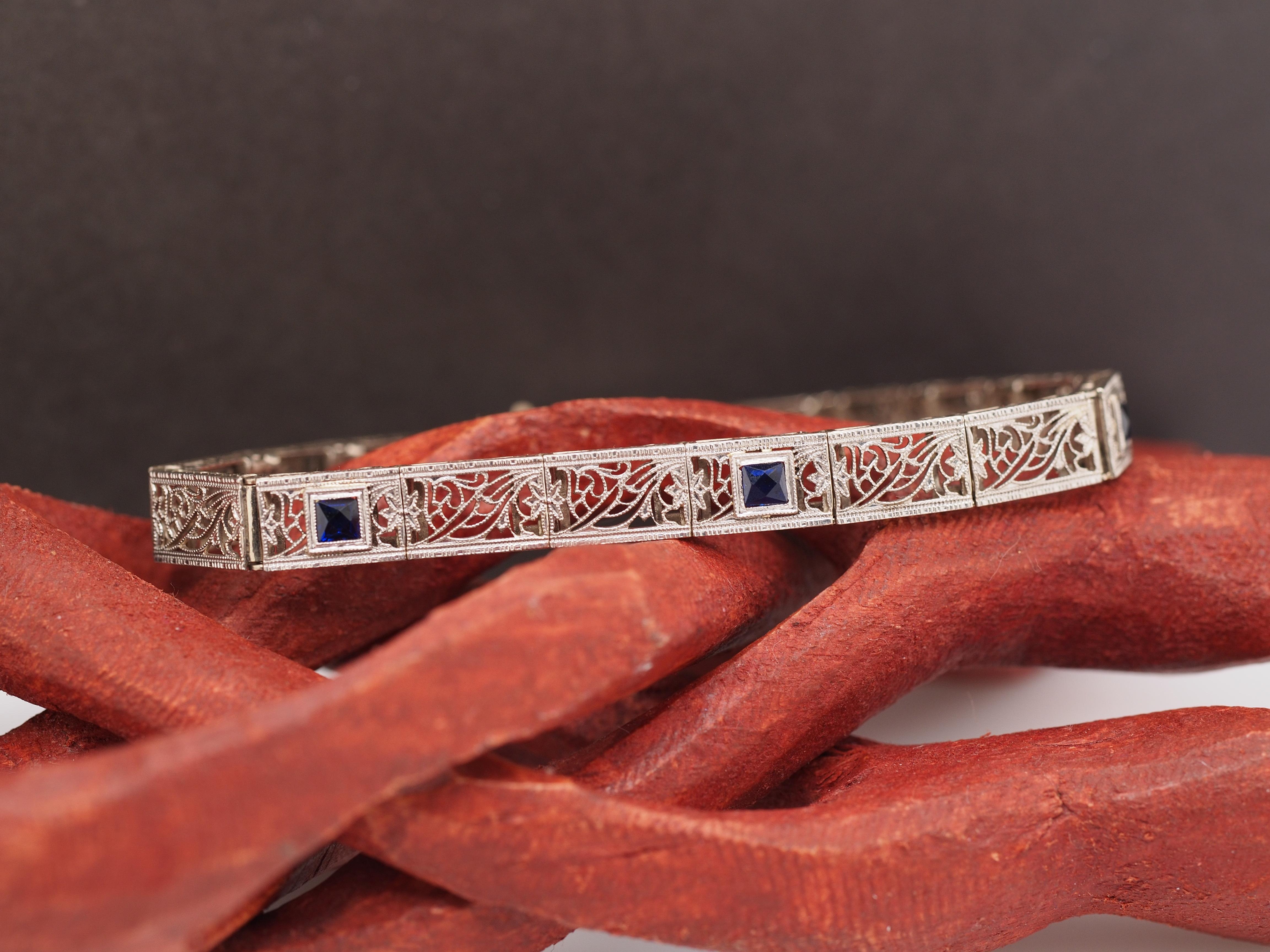 Year: 1920
Item Details:
Metal Type: 14K White Gold [Hallmarked, and Tested]
Weight: 10.1 grams (All Items Total)
Sapphire Details:
Type: synthetic
Weight: .50ct total weight
Cut: French Cut
Color: Blue

Info:

Bracelet Length Measurement: 6 Inches