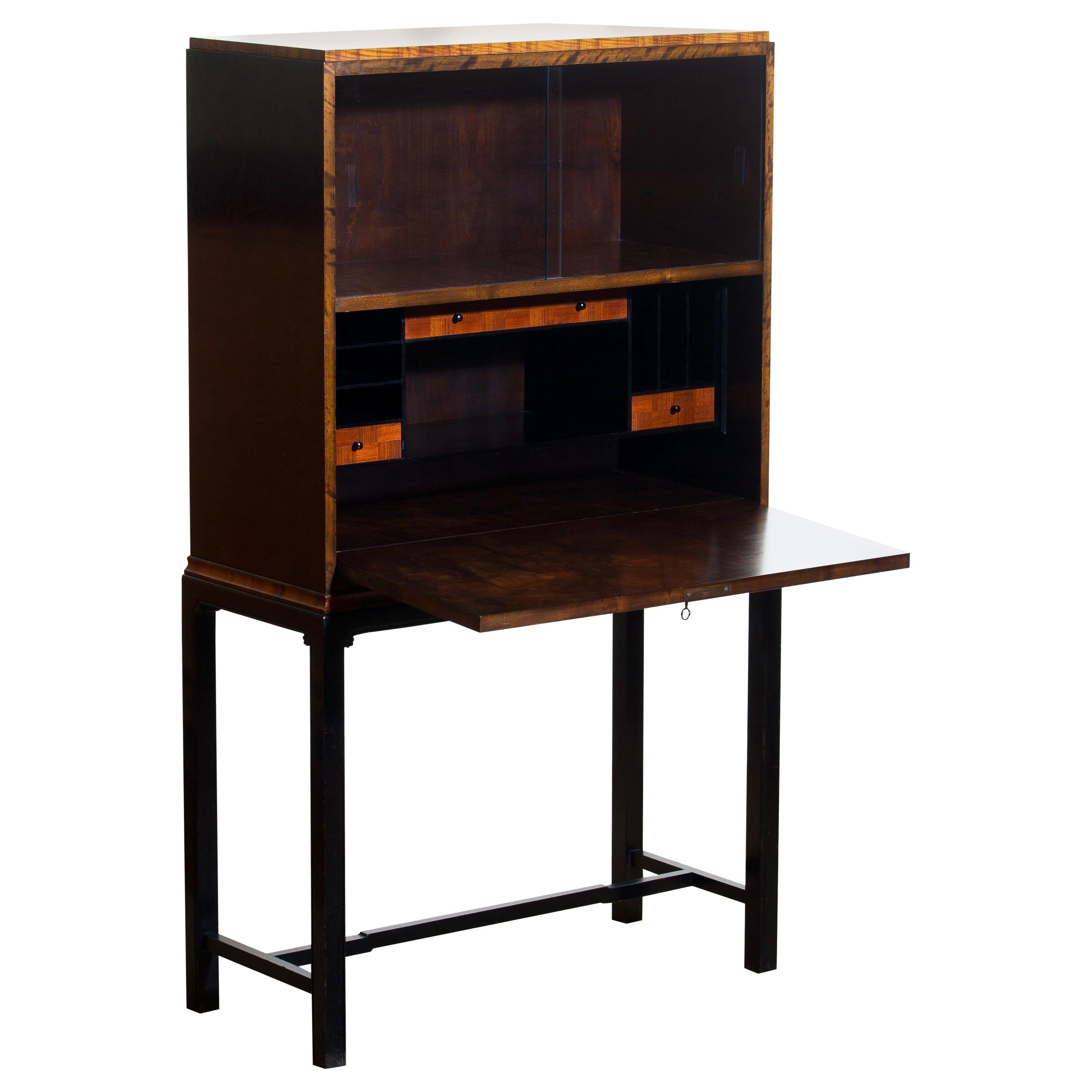 1920s, unique secretaire designed by Axel Einar Hjorth and manufactured in 1924 by Nordiska Kompaniet, numbered L228.
This unique Art Deco secretaire is designed as an come-in to the USA for Nordiska Kompaniet.

The secretaire is veneered with