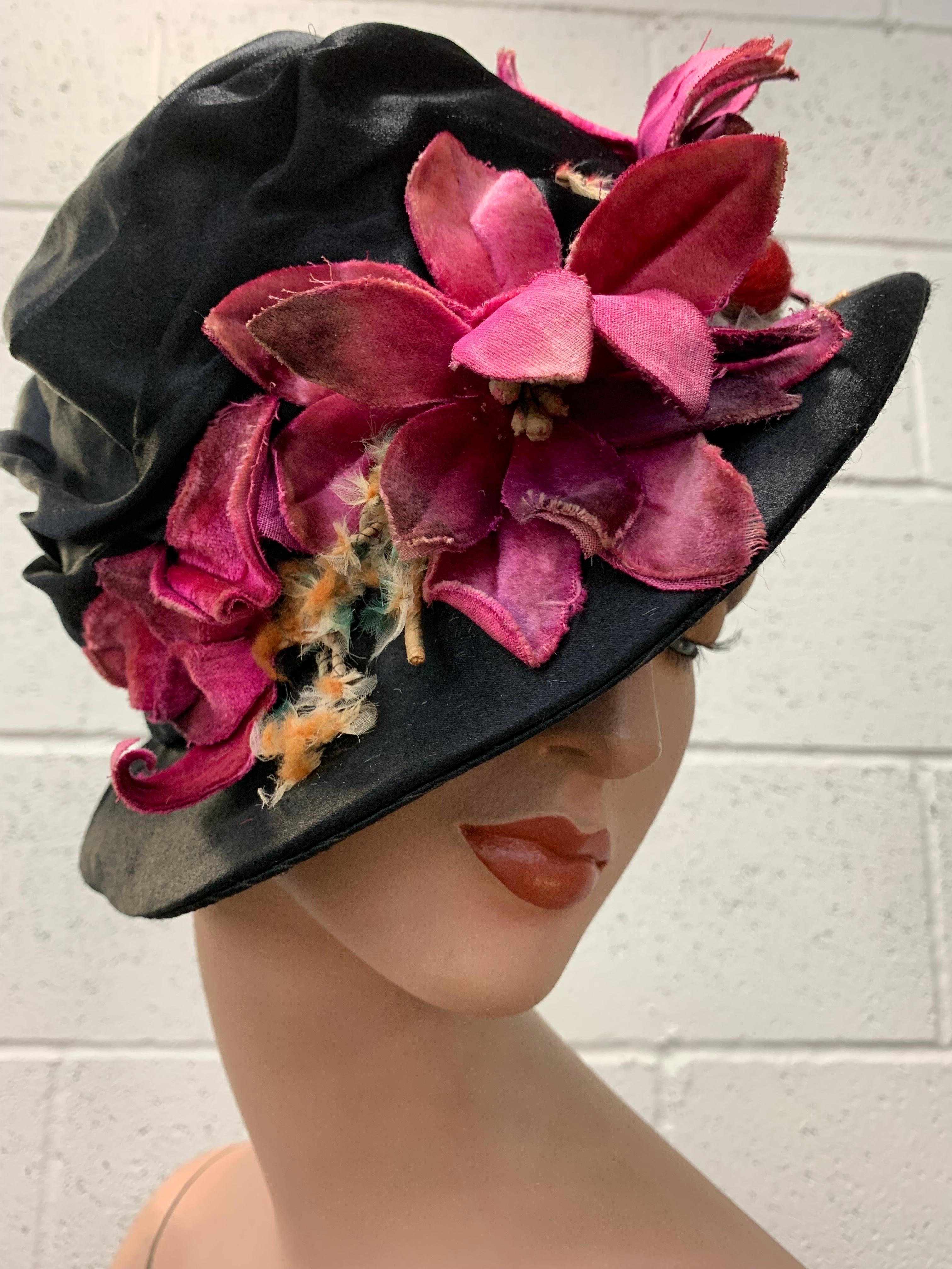 1920 Custom-Made Black Silk Satin Gathered Crown Brimmed Cloche w Magenta Velvet Florals: Small wired brim fitted cloche-style with magenta velvet flowers and a medley of other charming ornaments. Size Modern M-L. 