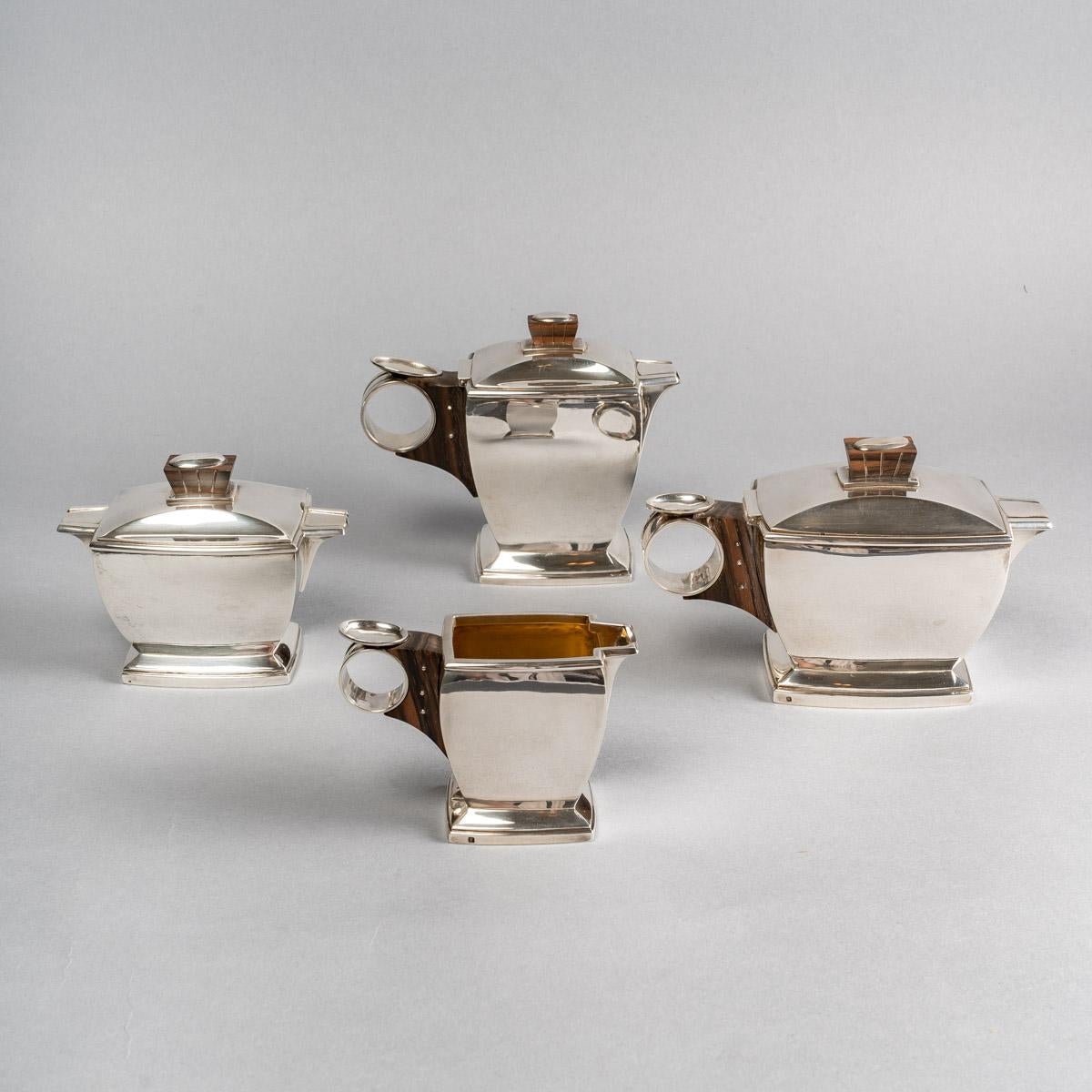 Tea and coffee egoiste set in sterling pure silver and macassar by BOin Taburet created in the 1920s.

Service including :
- a coffee pot: 12 cm x 14 cm
- a teapot: 11 cm x 17 cm
- a pot milk: 7 cm x 10 cm
- a sugar bowl: 9.5 cm x 12 cm

Minerve