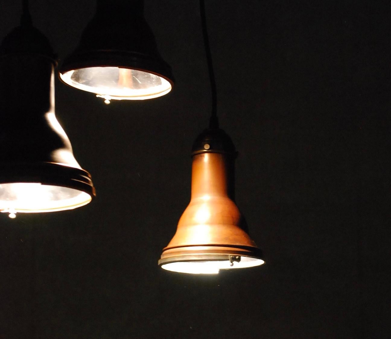 Set of 8 copper pendant lights salvaged from an old theatre in NYC. These copper bodies have a small brass cap holding the socket, with reflective metal interior for maximum effect.
Great lights. Please note cable will rest straight after a short