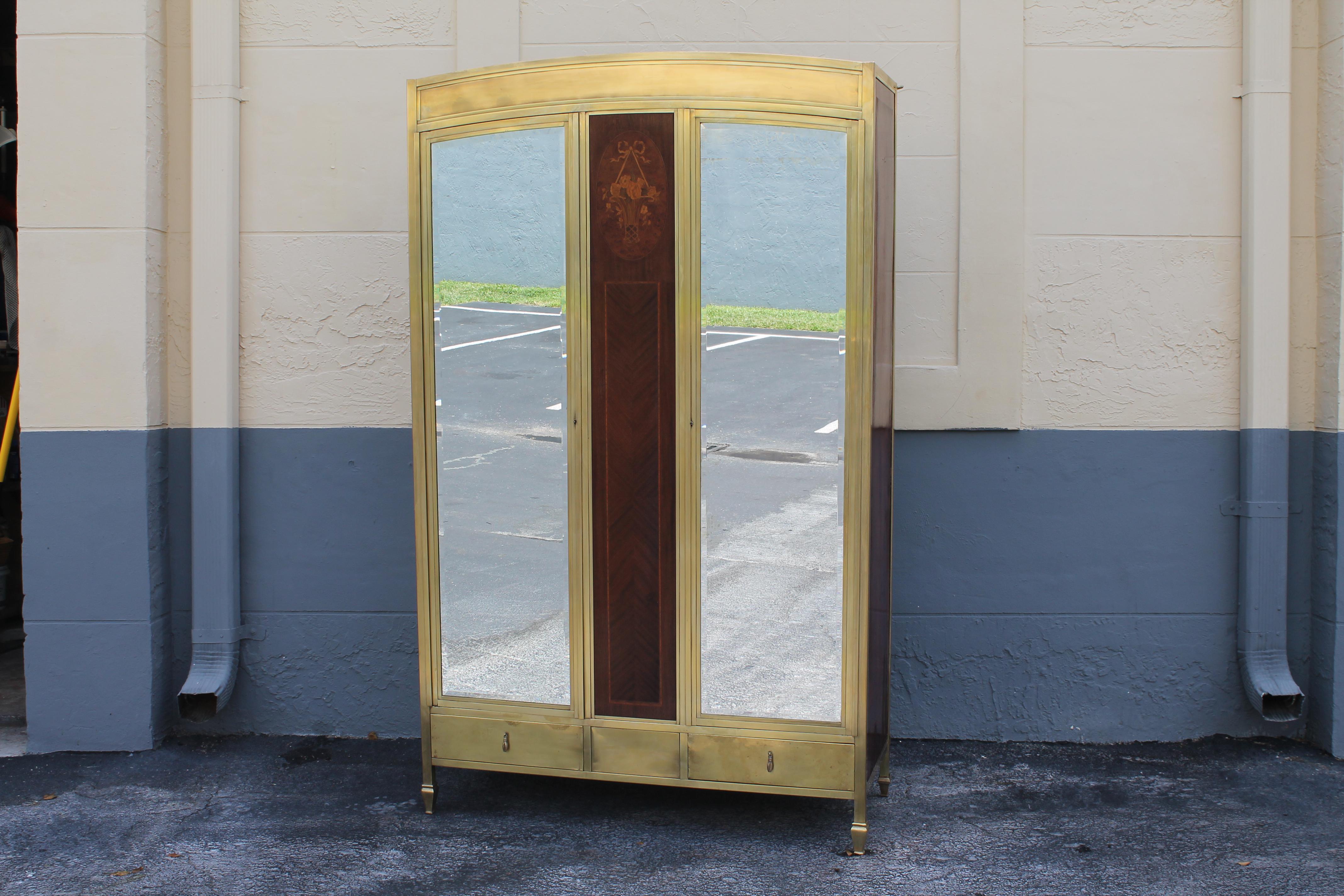 This 1920's French Art Deco Armoire/ Wardrobe is constructed with solid brass. It is of the highest quality. Heavy lugnuts on to fix the back onto the piece see this armoire comes apart into 11 solid parts for an easier shipping, if desired. This