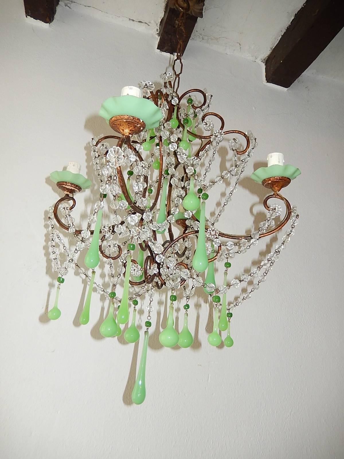 Housing four lights sitting in rare green ruffle opaline bobeches on top of chippy giltwood posts. Rewired and ready to hang. Swags of crystal balls and florets throughout. Murano green opaline drops and beads throughout. Free priority shipping from