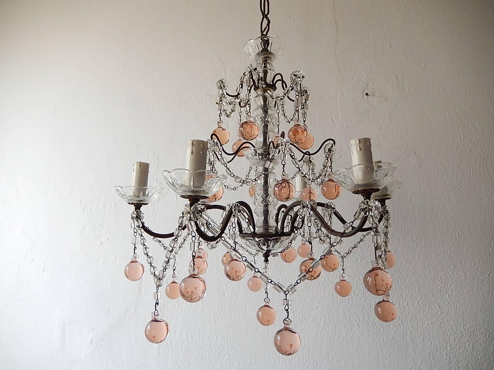 Housing six lights sitting in crystal bobèche. Will be rewired with certified US UL sockets for USA and appropriate sockets for all other countries and ready to hang. Metal with glass florets and macaroni beading swags throughout. Rare pink Murano