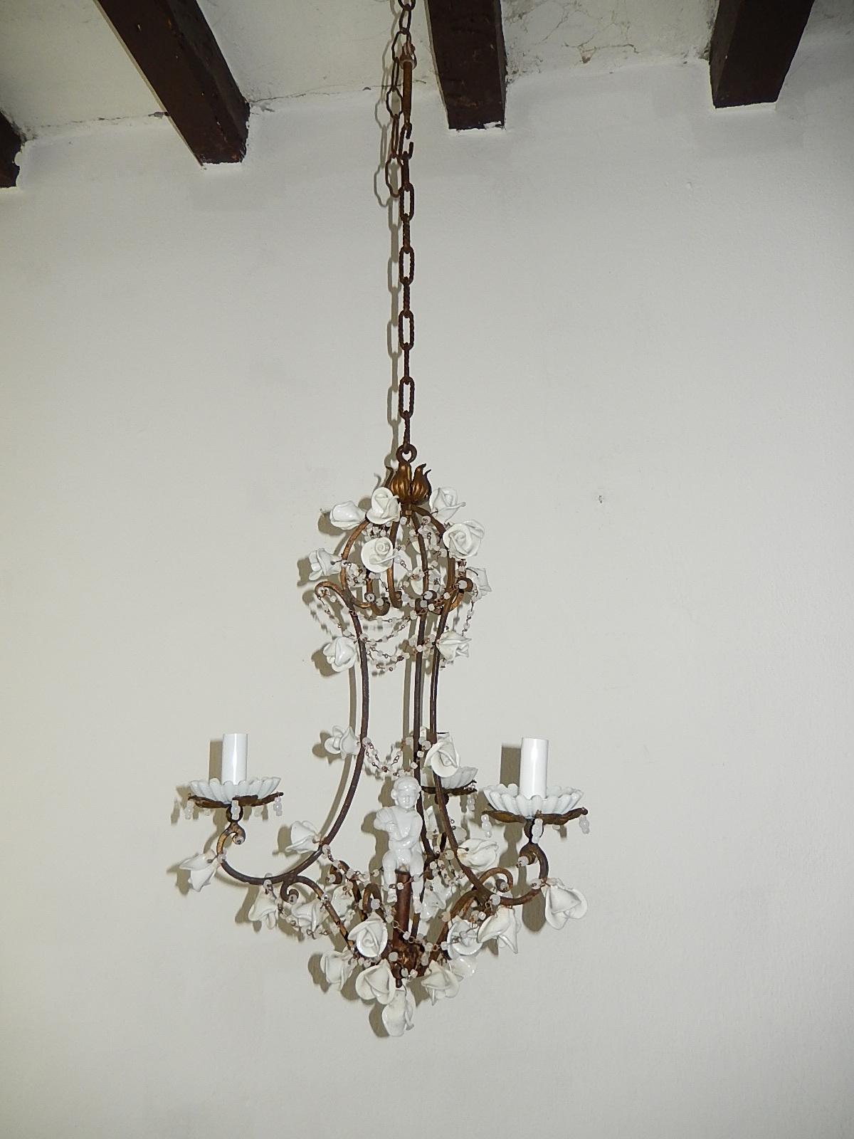 Housing 3 lights, sitting in white opaline cups. Will be rewired with appropriate sockets for country and ready to hang. Dark patina metal frame (flash makes it look rusty which it is not) with swags of white opaline macaroni beads. Adorning