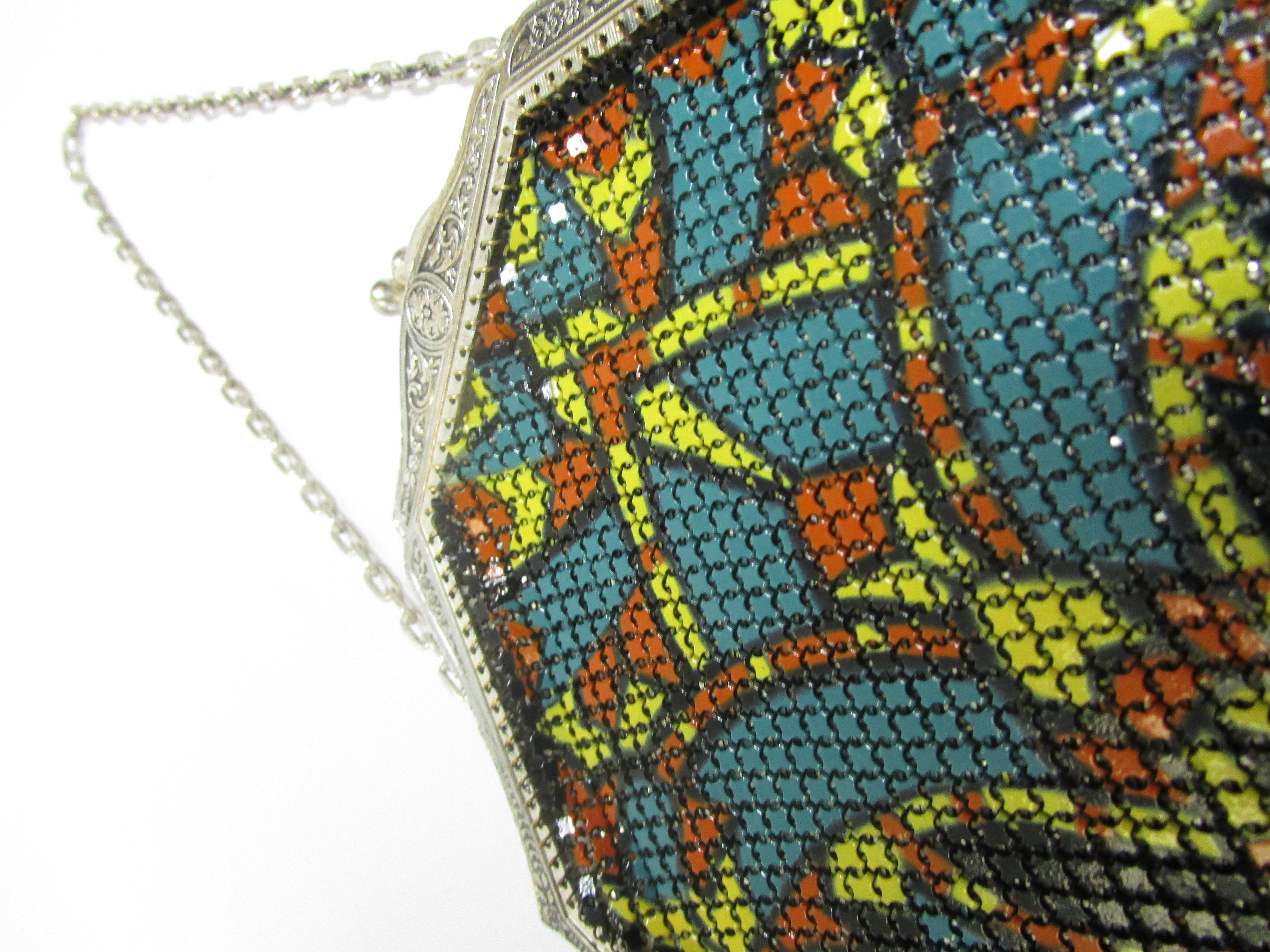 
Take a look at this truly dazzling mesh bag by the Mandalian Mfg. Company! It features an intricately painted symmetrical abstract design, a silver kiss lock and fringe that hangs from the bottom of the bag. 
Not much is known about Sahatiel
