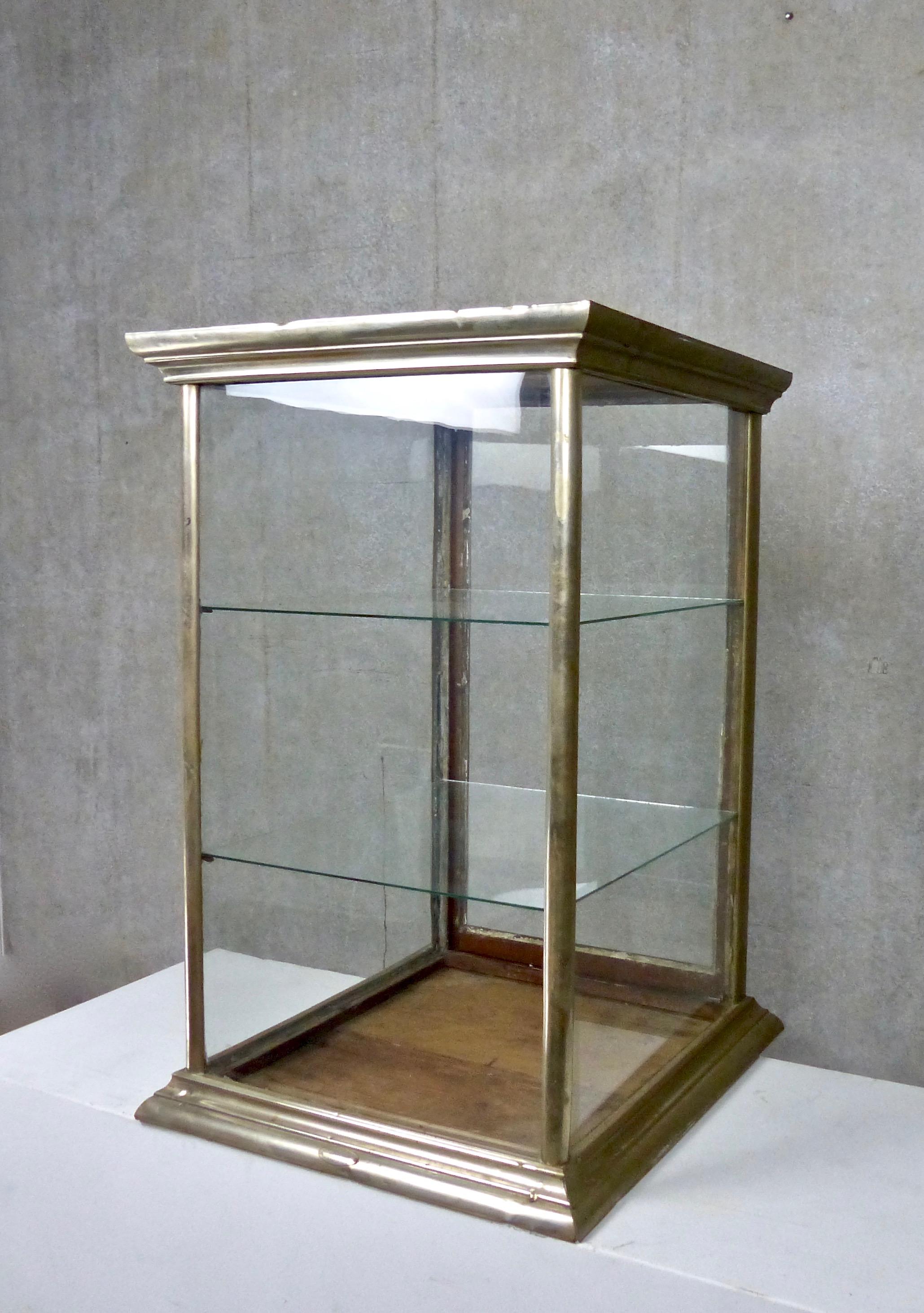 Tabletop display cabinet with glass on four slides and an intact, nickel-plated wood frame, circa 1920. The rear panel slides up to open. Mercantile unit includes two interior glass shelves. Dimensions: 31 H” x 20 W” x 21 D”.
 