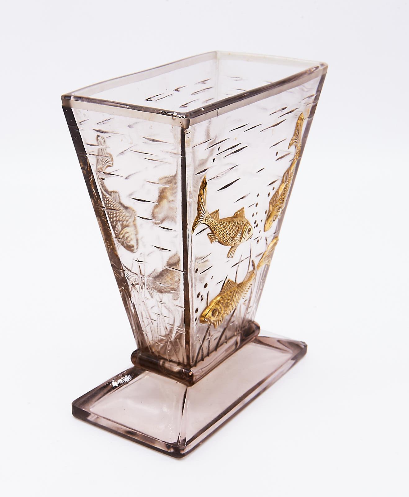 A scarce rectangular funnel form glass vase on a rising base. The front and back panels are moulded with high relief gilt decorated fish - the eyes are left clear - swimming amongst weeds, with additional water ripples and bubbles on all sides.