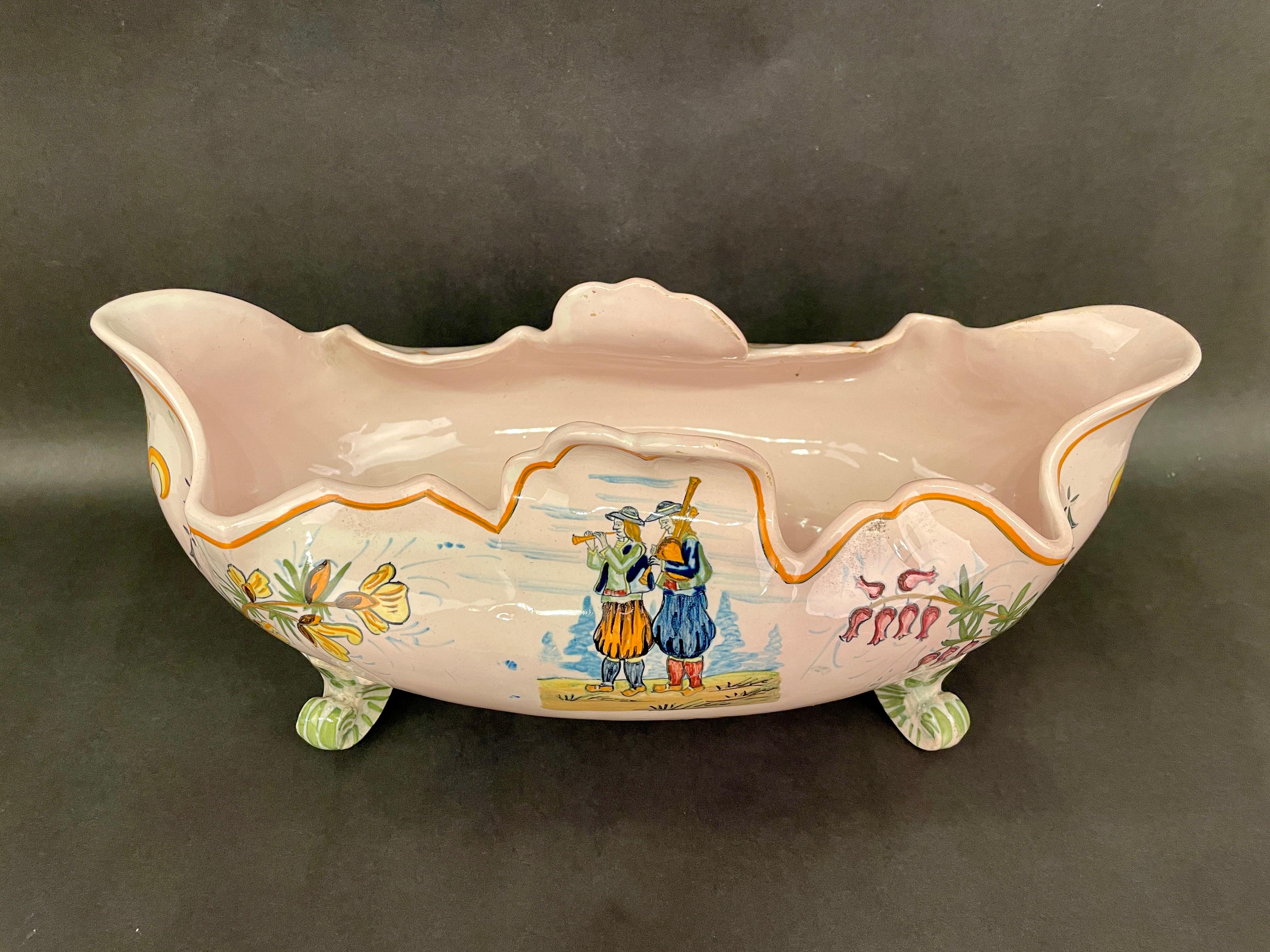 A good faience jardiniere from Henriot Quimper, depicting two musicians on one side and the coat of arms of Bretagne on the other with a fleur de lis on each end. In good condition with minor wear. No repairs or chips. Circa 1920-1930
12.5