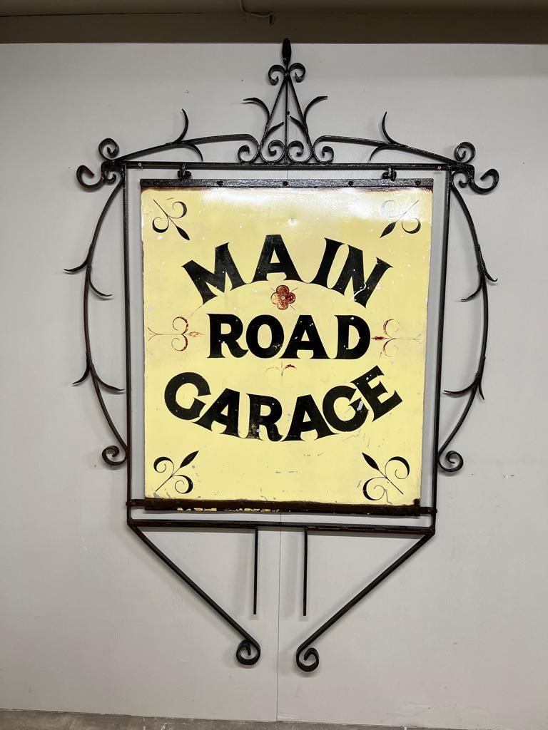 Circa 1920 Very Large Wrought Iron Double-Sided Hanging Sign — “Main Road Garage” 

An exceptional and impressively scaled circa 1900 wrought iron double-sided sign, this striking piece once advertised a local “Main Road Garage” during the early era