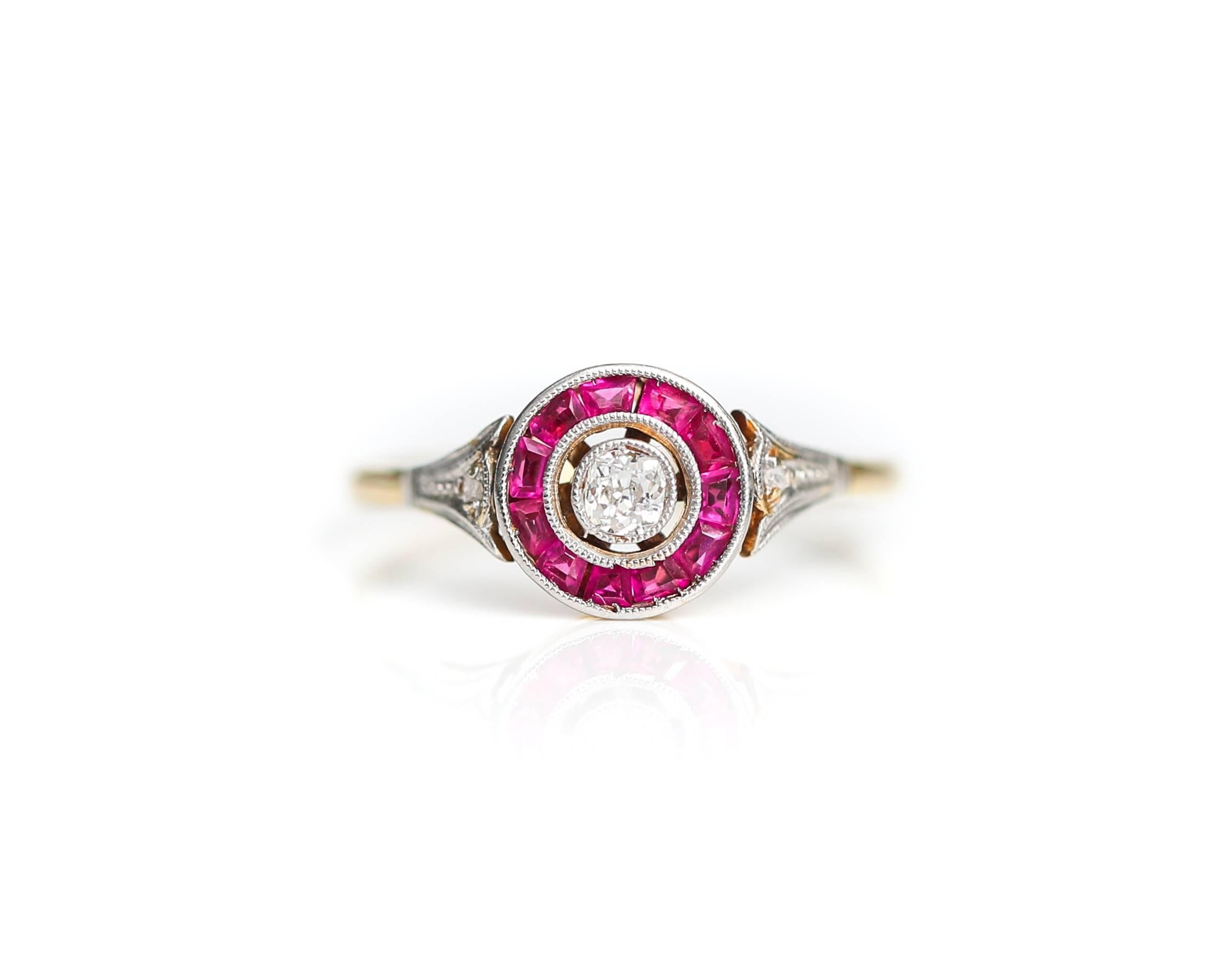 1920s Art Deco .25 Carat Old Mine Round Cut Diamond Ring with Ruby Halo and 14 Karat Yellow Gold 

Features an Old Mine Round cut Center Stone, 2 Rose cut Accent Diamonds and Rose cut Rubies. 
The .25 Carat Center Stone is nestled in a bezel setting