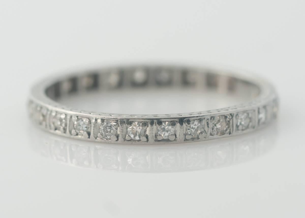 1920s Art Deco 2.5 millimeter wide Diamond and 14 Karat White Gold Eternity Band

This dainty ring features .40 carats of prong set, Single cut Diamonds all the way around. The upper and lower edges of the band are flat with a delicate etched