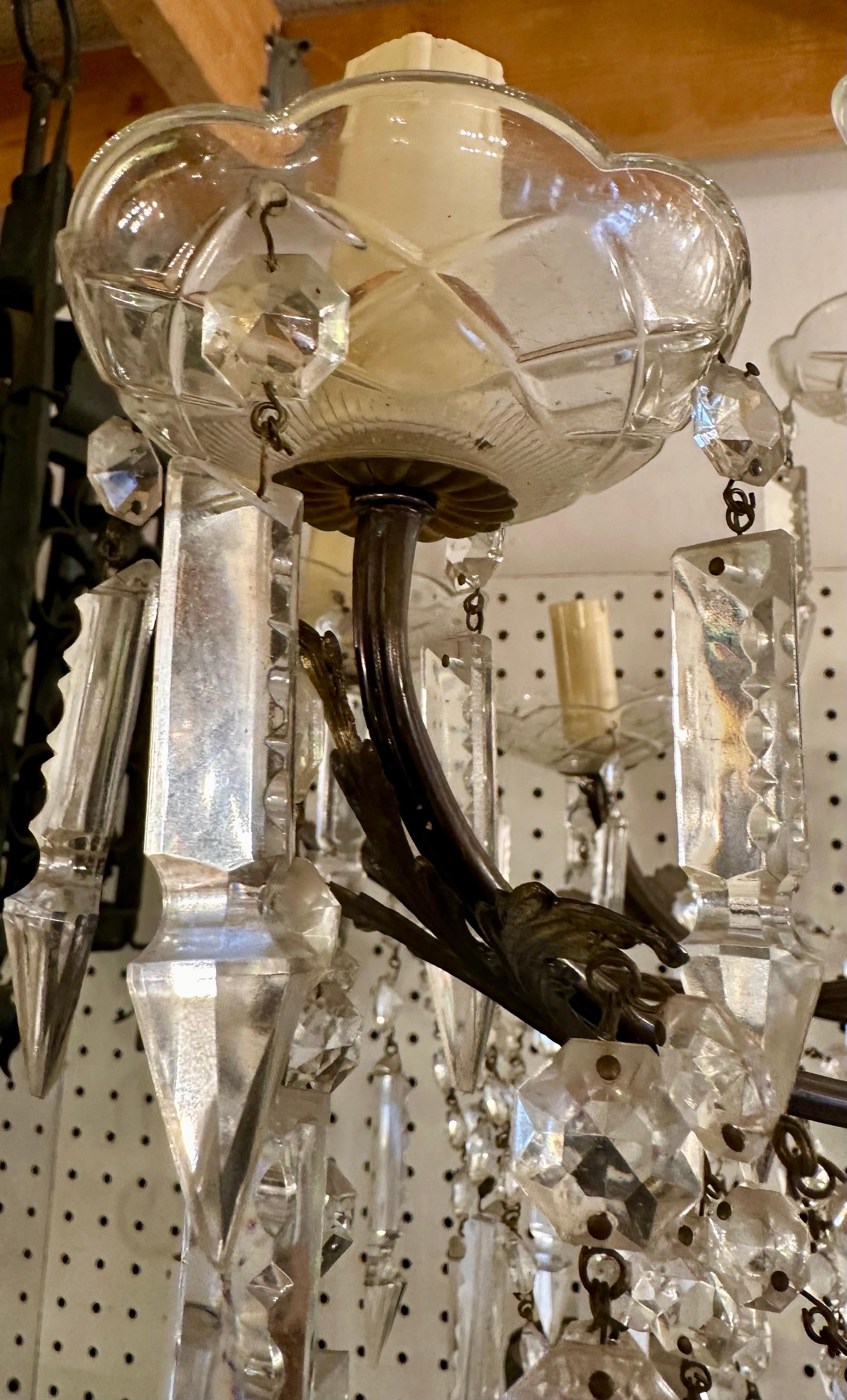 Absolutely gorgeous crystal and bronze chandy with a multitude of lights! This would be entirely too lovely over a prestigious dining table, or even as a focal point in a bathroom in your estate! Contact us today to purchase! 