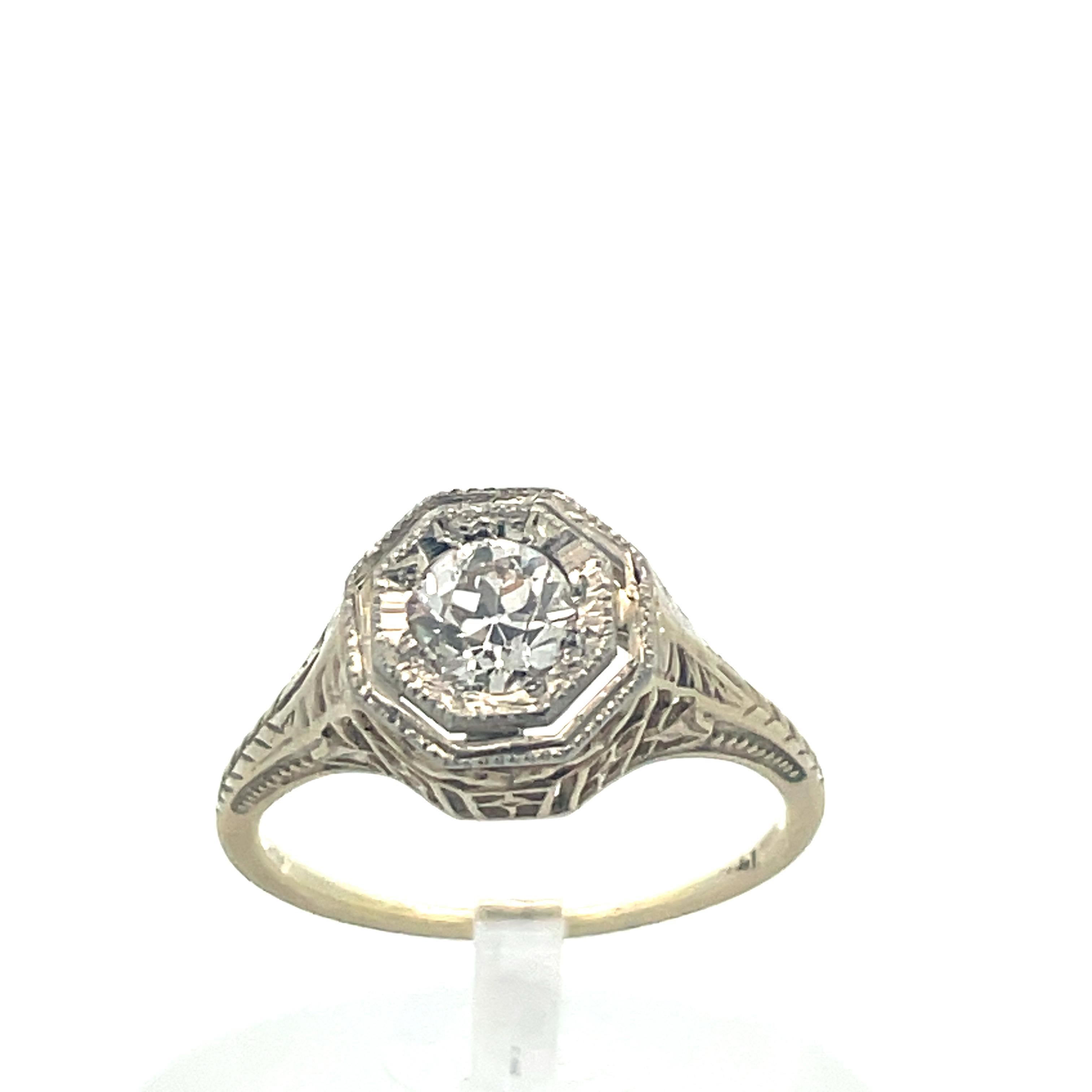 1920s 14k Yellow Gold and Platinum Filigree Diamond Ring 

- 14k yellow gold and platinum 
- .40 ct Euro cut SI1/SI2 Diamond 
- Size 5 

This is a stunning ring from the 1920s made from 14k yellow gold and platinum with a euro cut diamond. The band