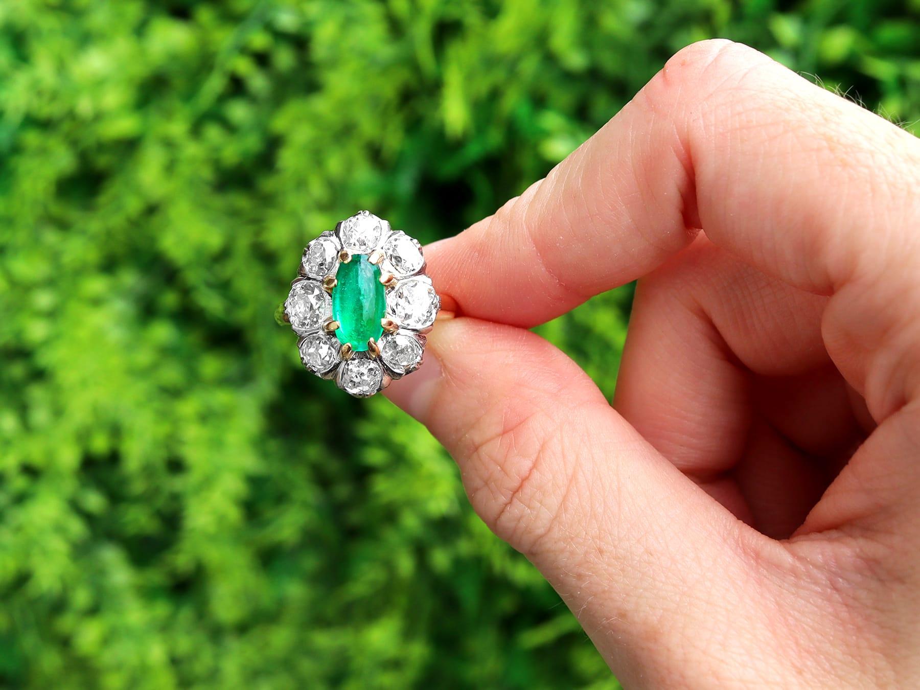 A stunning antique 1.50 carat Colombian emerald and 2.85 carat diamond, 18 karat yellow gold and platinum set dress ring; part of our diverse antique jewelry collections.

This stunning, fine and impressive cabochon cut emerald and diamond cluster